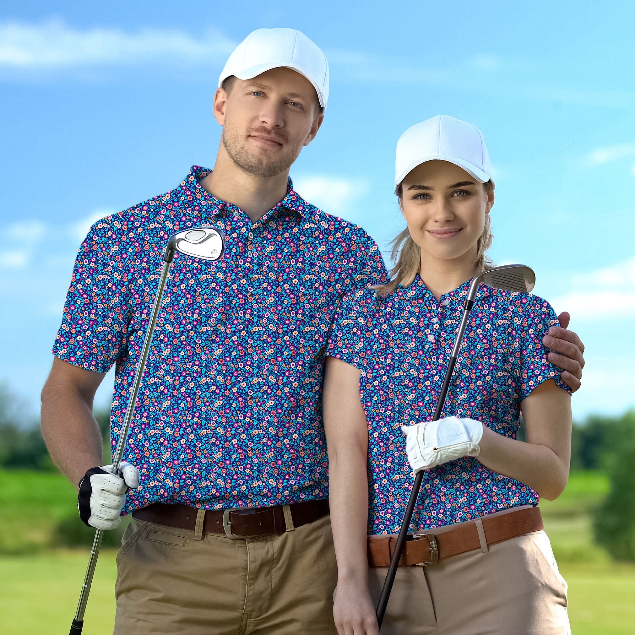 Couple wearing dark floral golf shirts with white caps holding golf clubs on a course