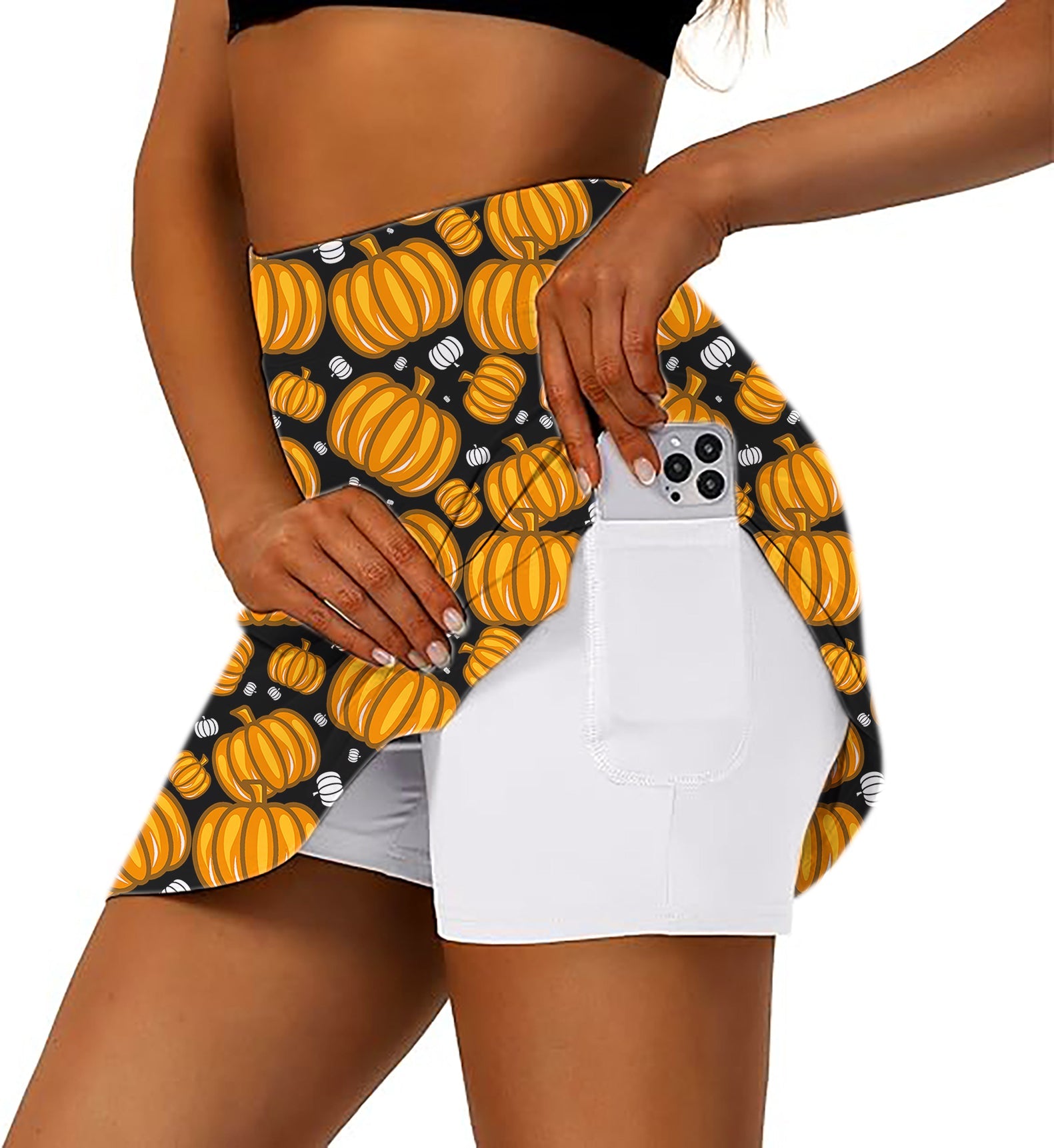 Women's Halloween pumpkin family golf skirt with inner shorts and side pocket holding phone