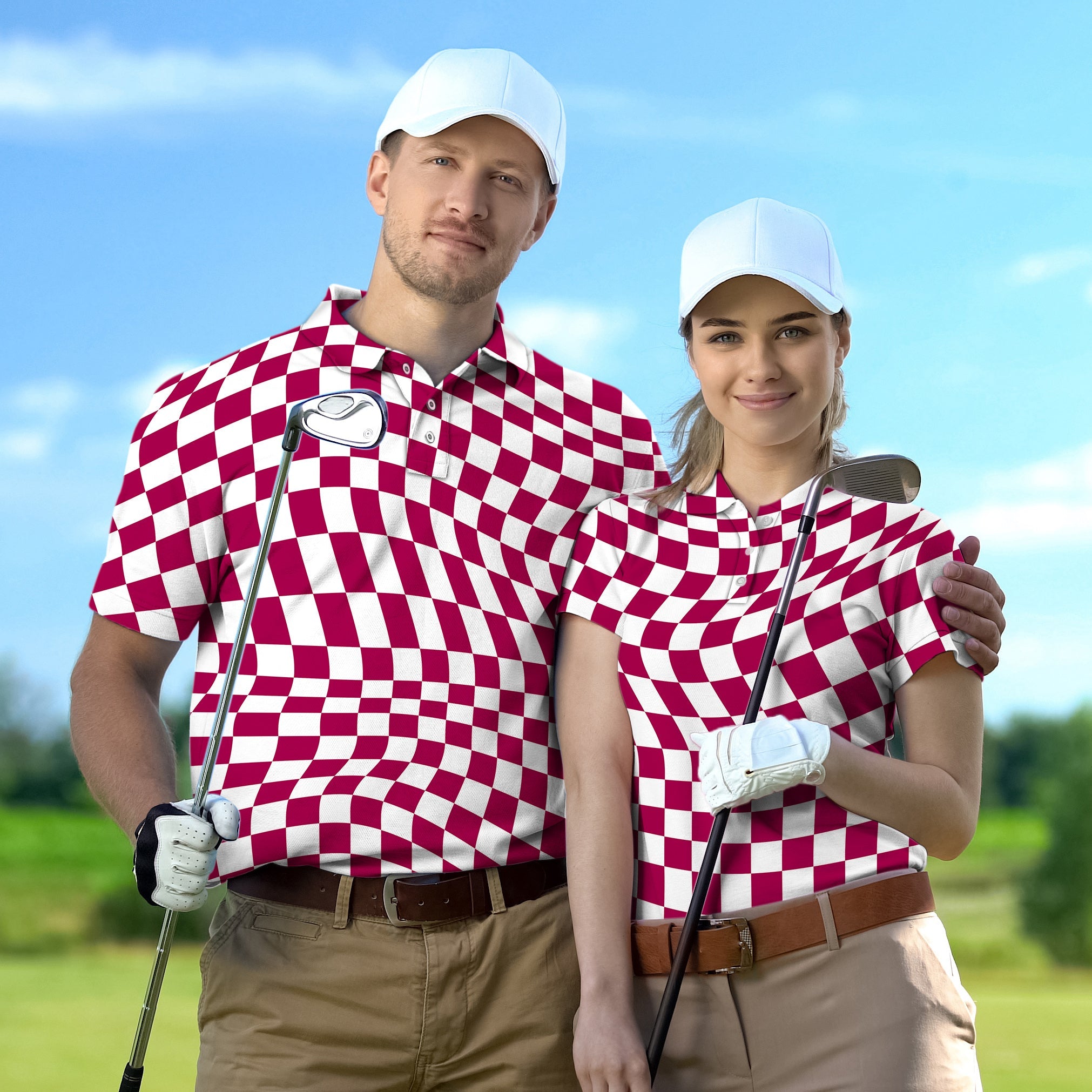 Couple wearing distorted checkerboard golf shirts with white caps holding golf clubs on course