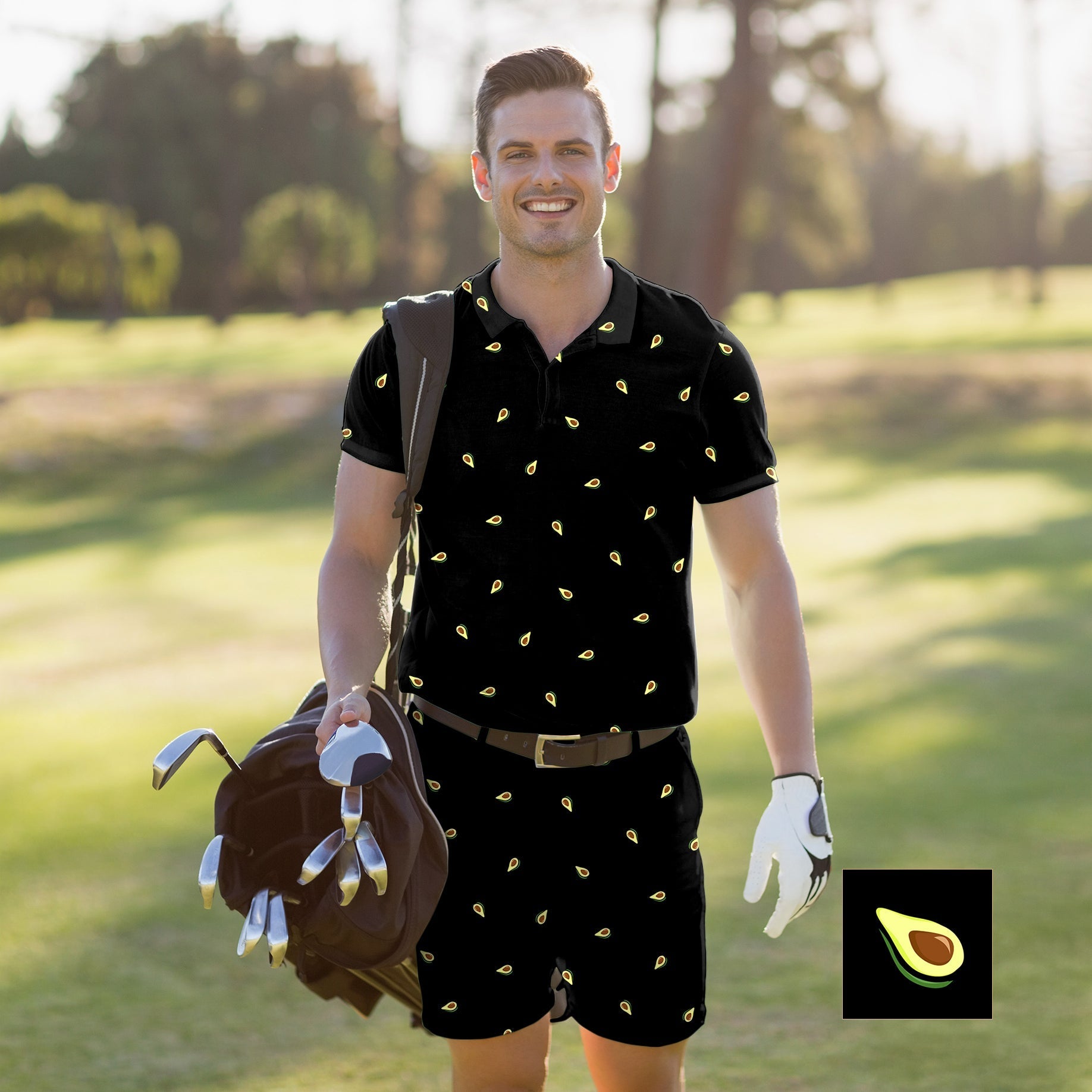 Man wearing black men's golf set polo and shorts with avocado print on golf course carrying golf clubs