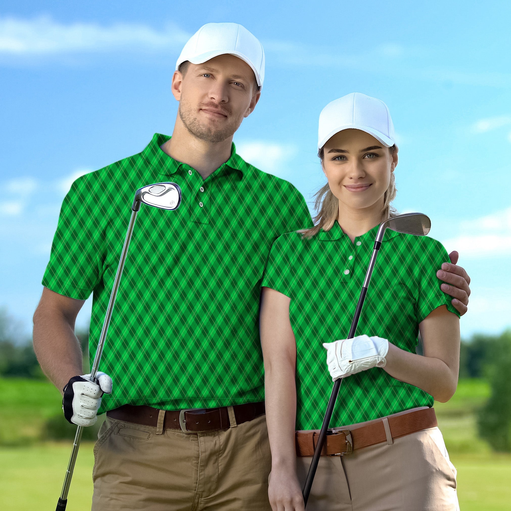 Couple wearing green plaid golf polo shirts with white caps holding golf clubs on a sunny course