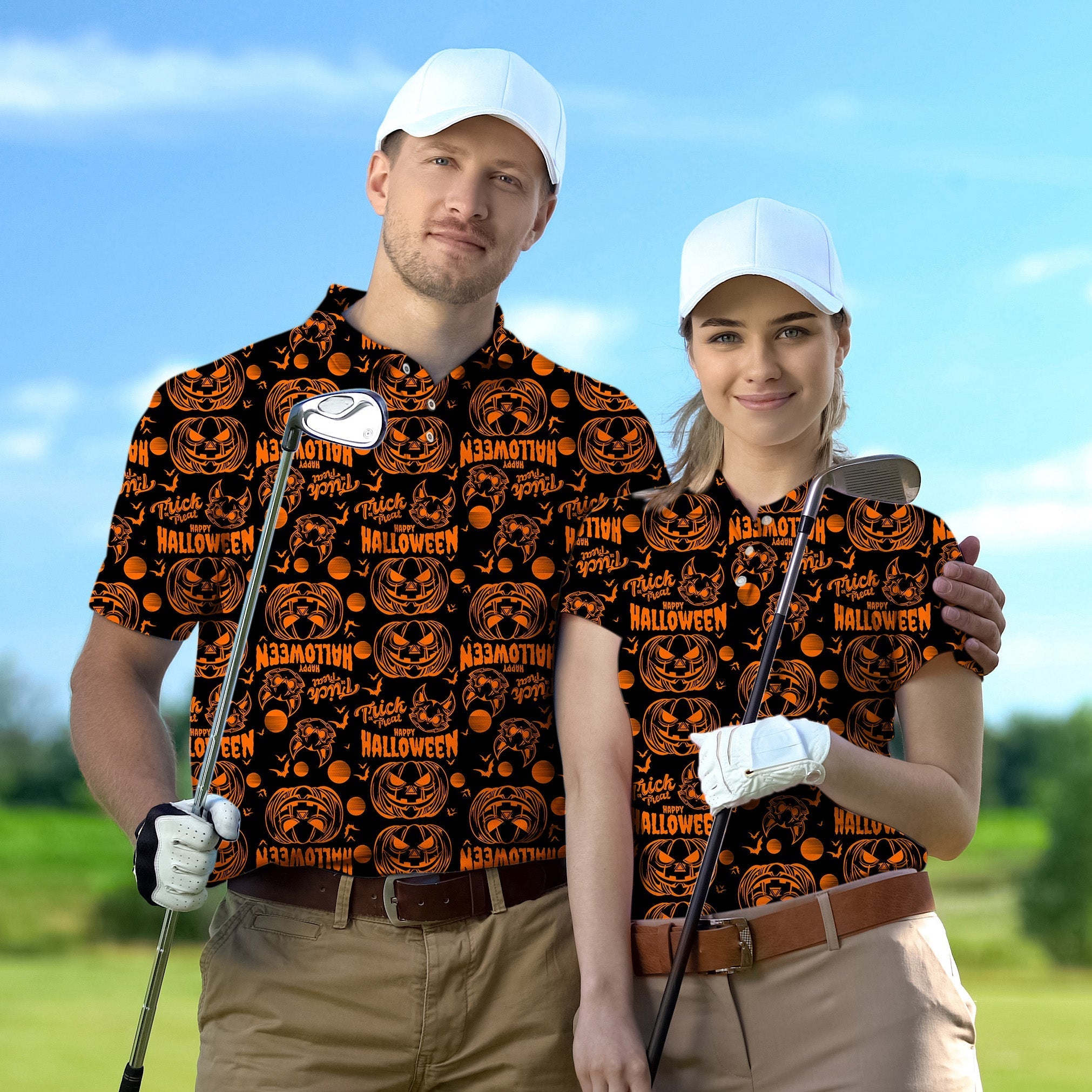 Couple wearing Happy Halloween themed golf shirts holding golf clubs on a green golf course