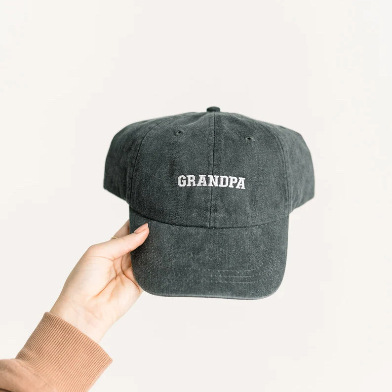Black vintage baseball cap with embroidered GRANDPA text held in hand, personalized dad hat Father's Day gift