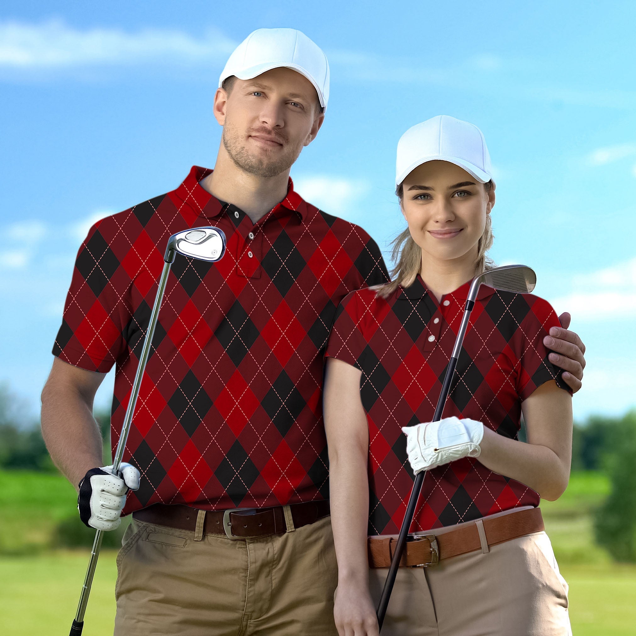 Couple wearing red Argyle set golf shirts holding clubs on course