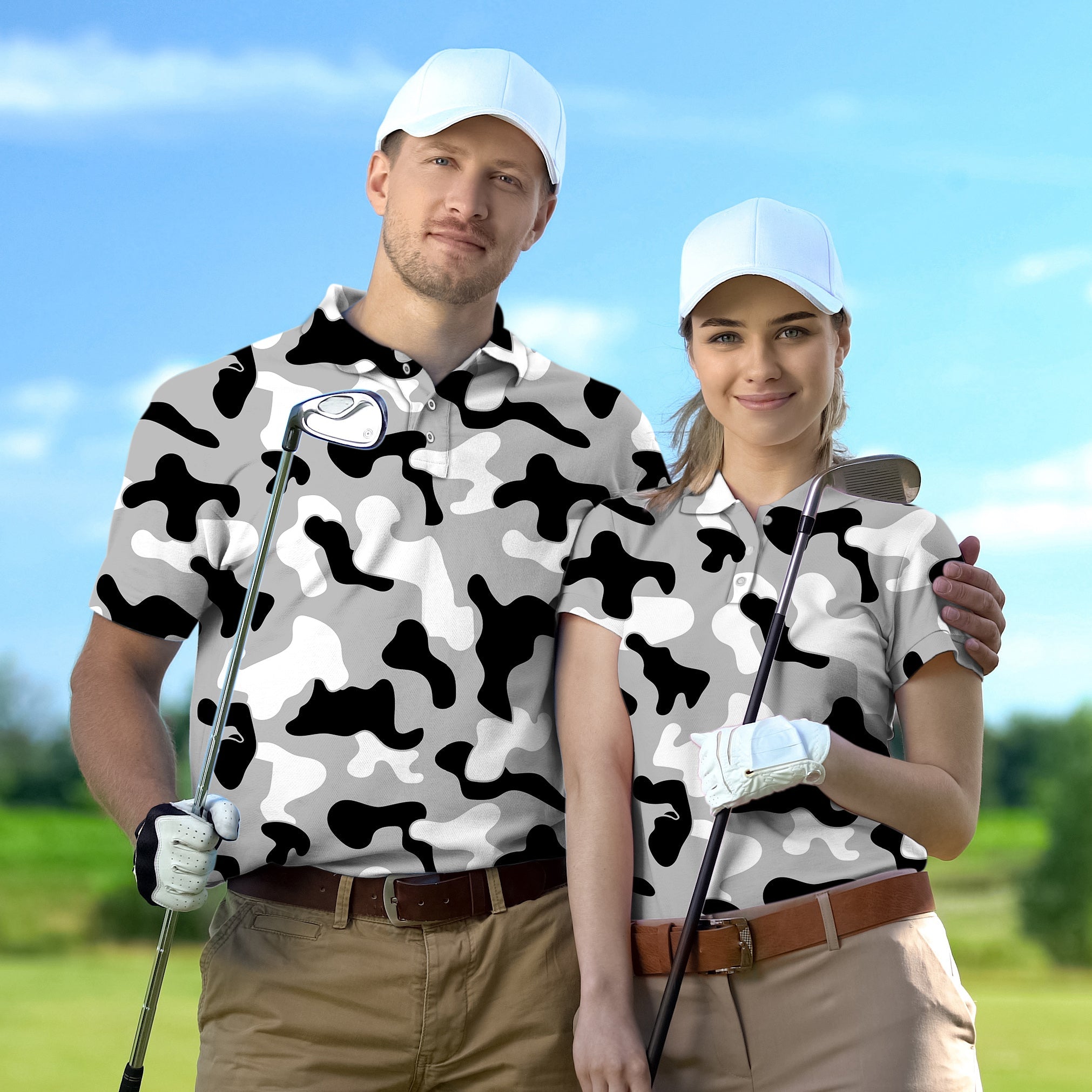 Couple wearing grey camouflage golf polo shirts with caps holding golf clubs on a sunny day