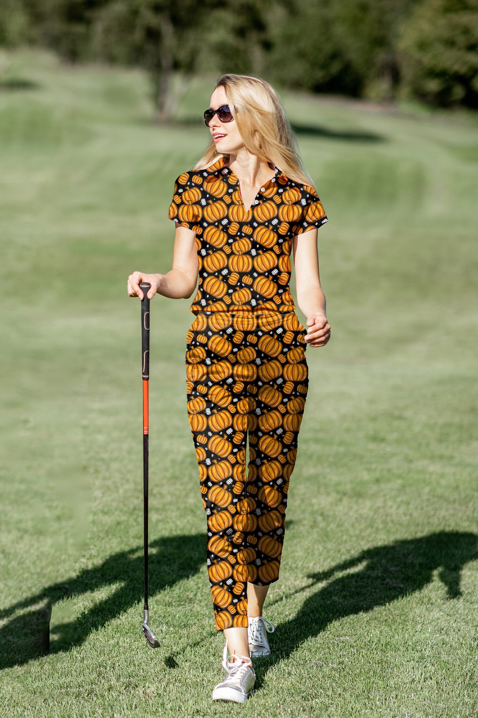 Women's golf polo and pants set with Halloween pumpkin pattern, stretchy and moisture-wicking fabric, designed for comfort and style on the green