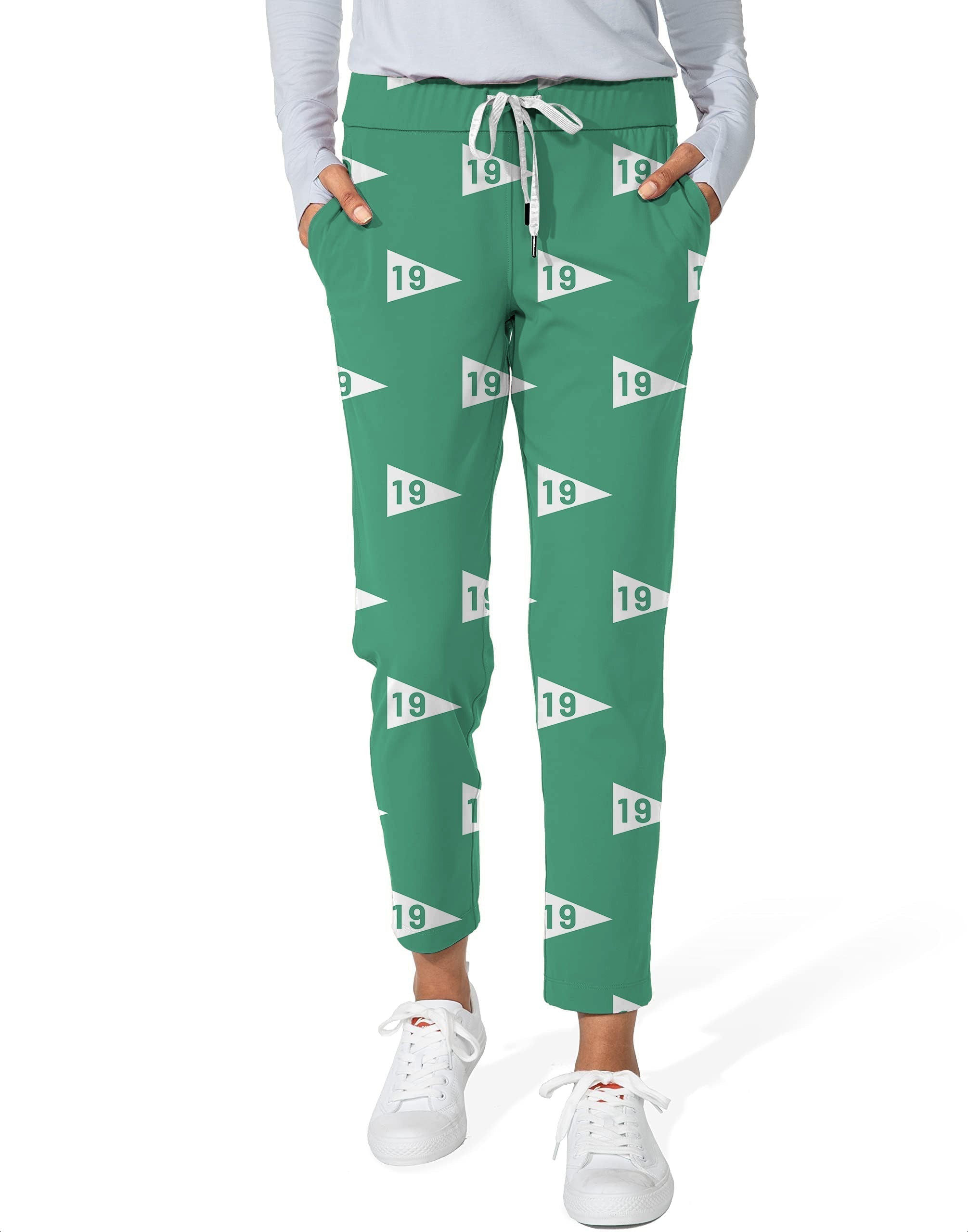 Green women's 7/8 stretch ankle golf pants with 19 logo, elastic waistband, and side pockets