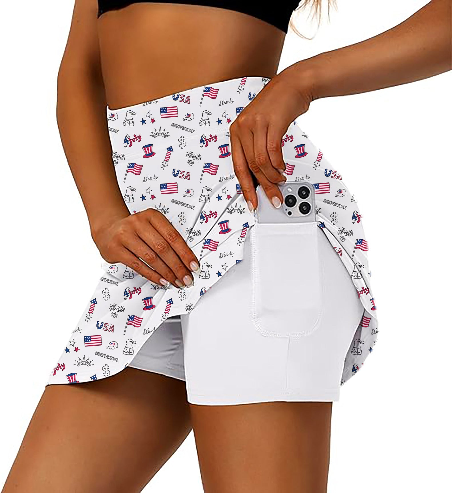 Women's American flag golf skirt with inner shorts and side pocket holding smartphone