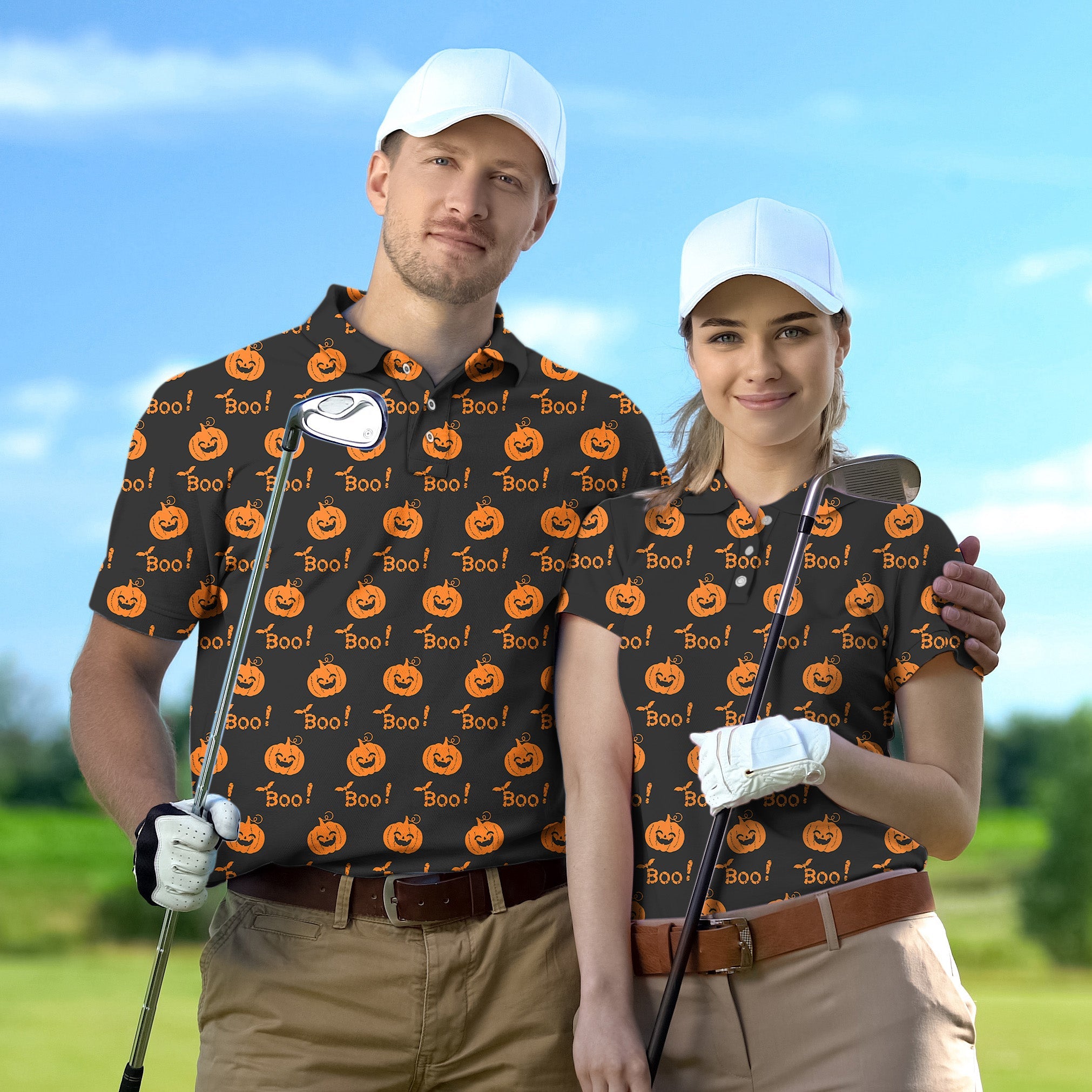 Couple wearing matching Halloween Boo pumpkin golf shirts holding clubs on golf course