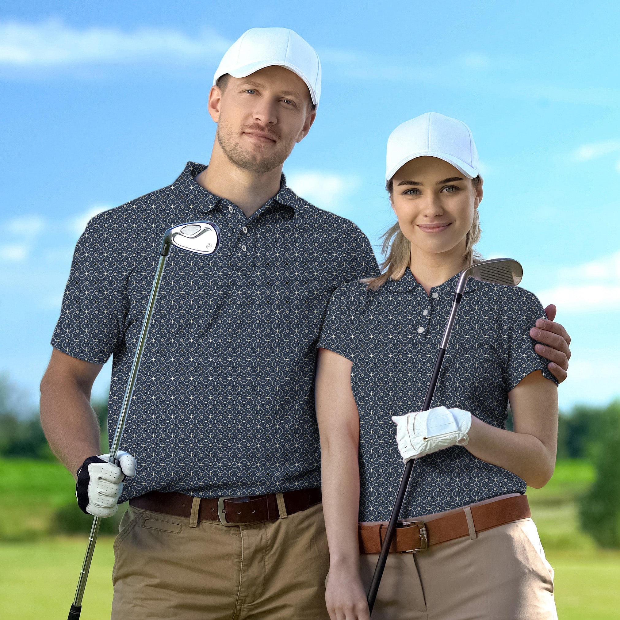 couple wearing navy blue floral golf polo shirts with white caps holding golf clubs on golf course