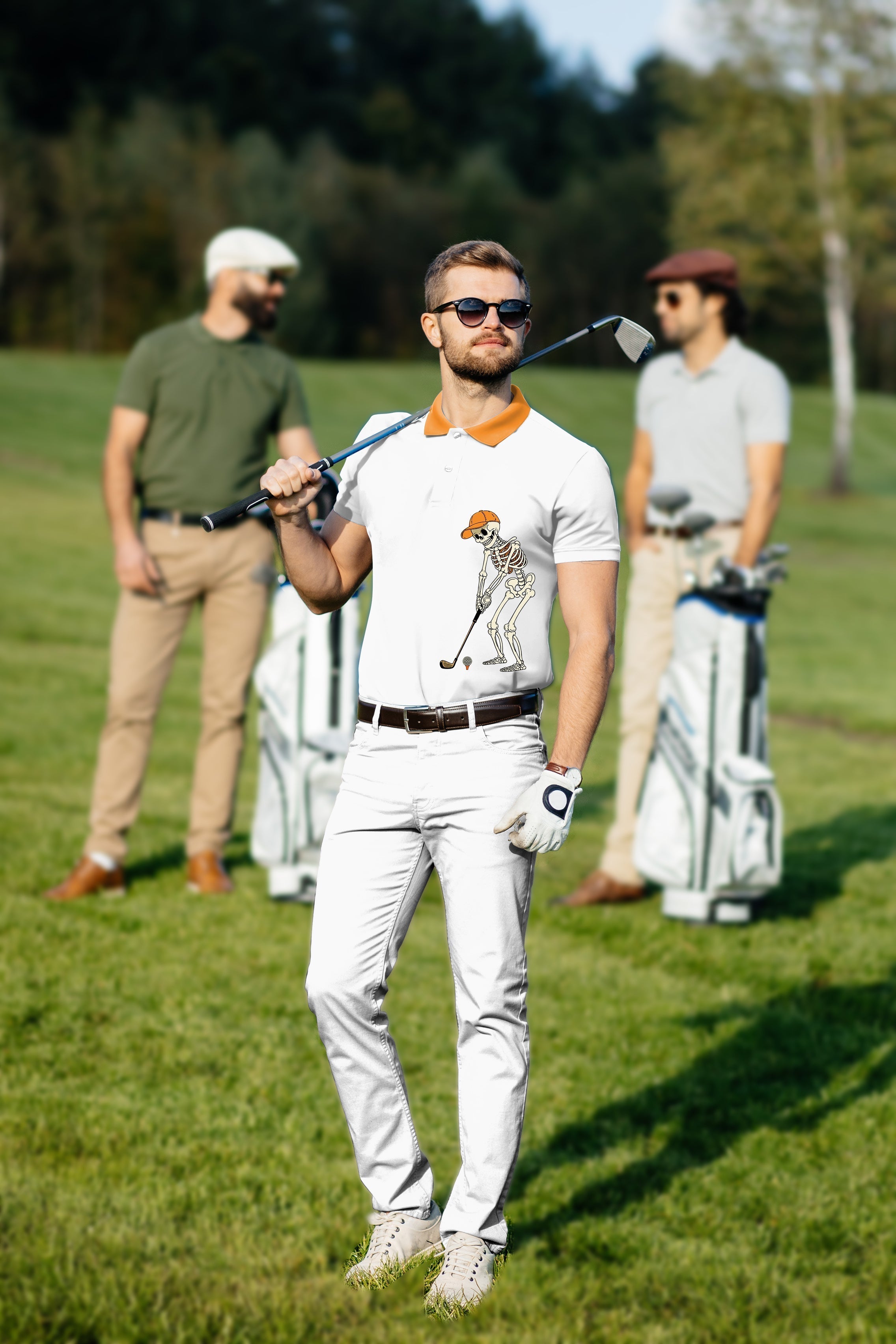 Men's golf set with pumpkin white polo featuring skeleton design and white pants on golf course