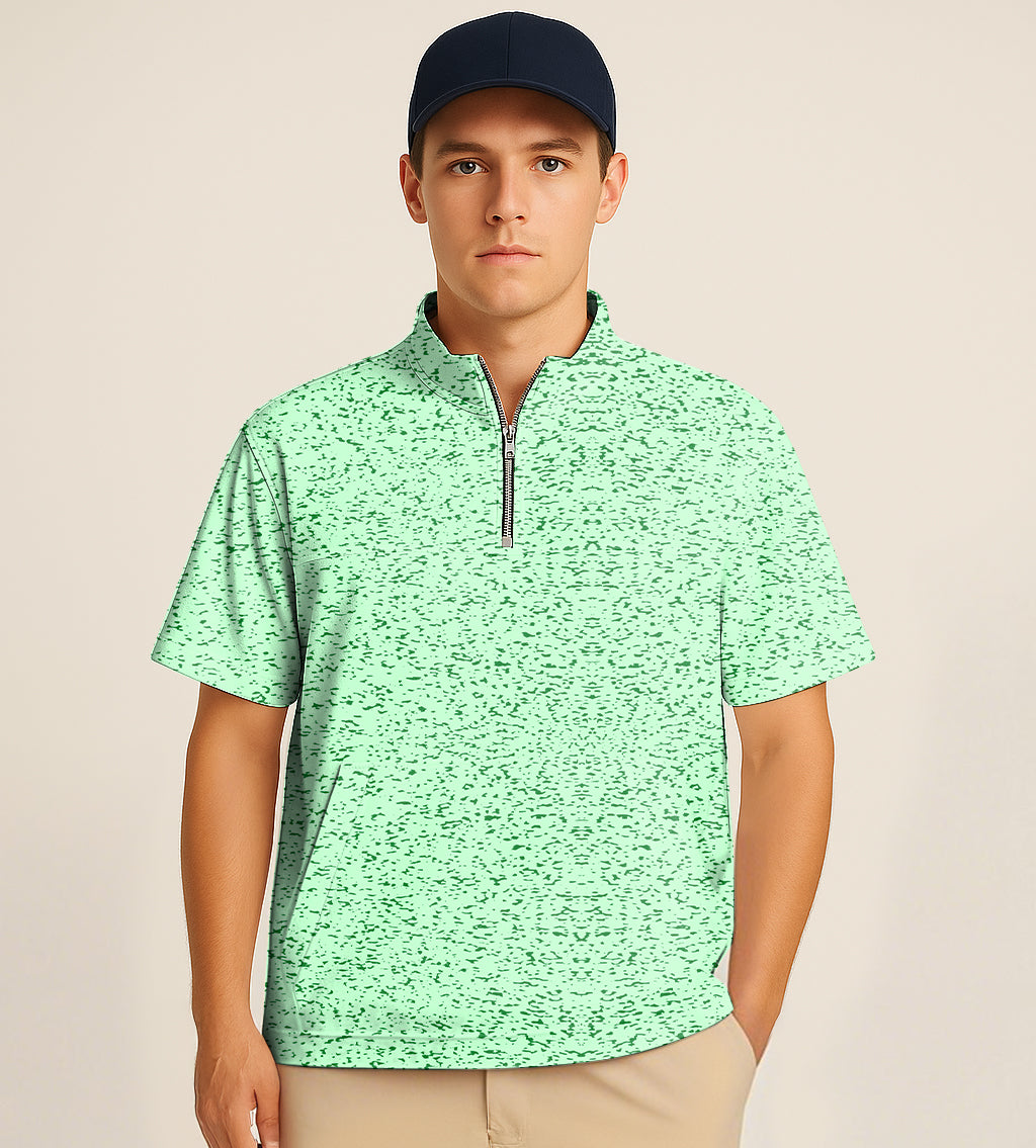 Man wearing a mint green half zipper turtleneck golf shirt with short sleeves and graffiti greens embroidery