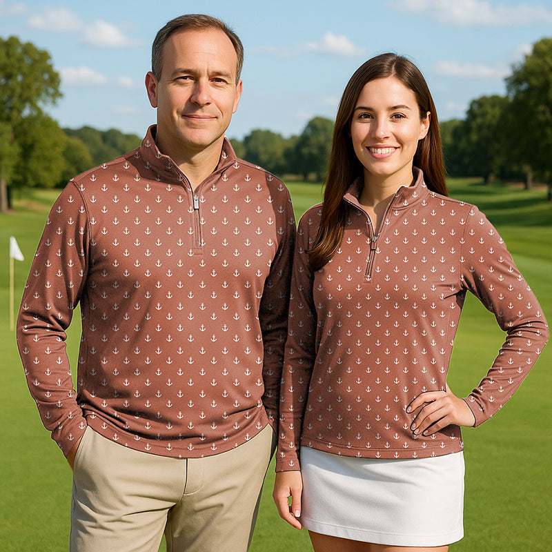Couple wearing dark orange anchor print 3/4 zip golf tops with long sleeves on golf course