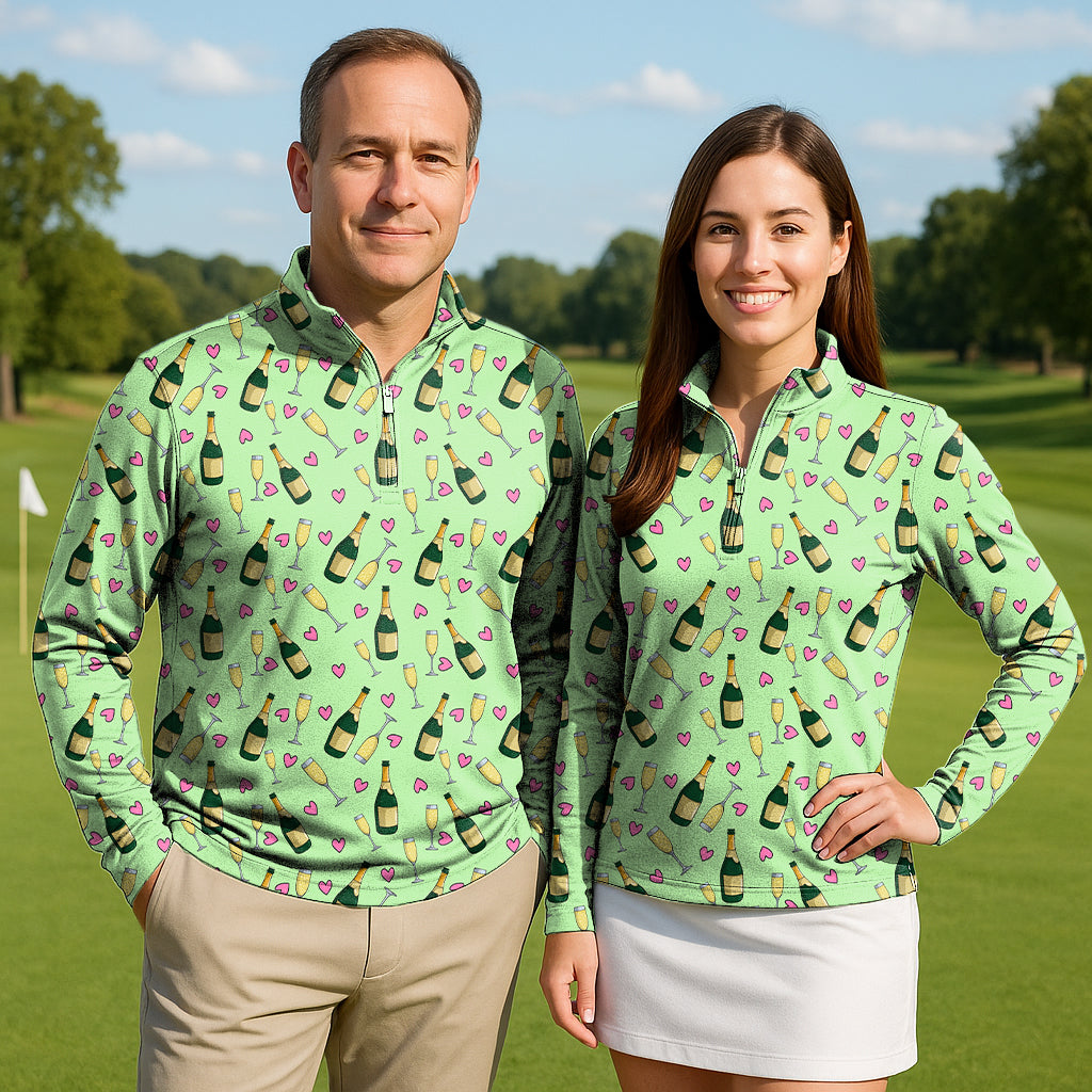 Couple wearing Friday Feeling Polo golf active 3/4 zip tops with champagne bottle and glass print on golf course
