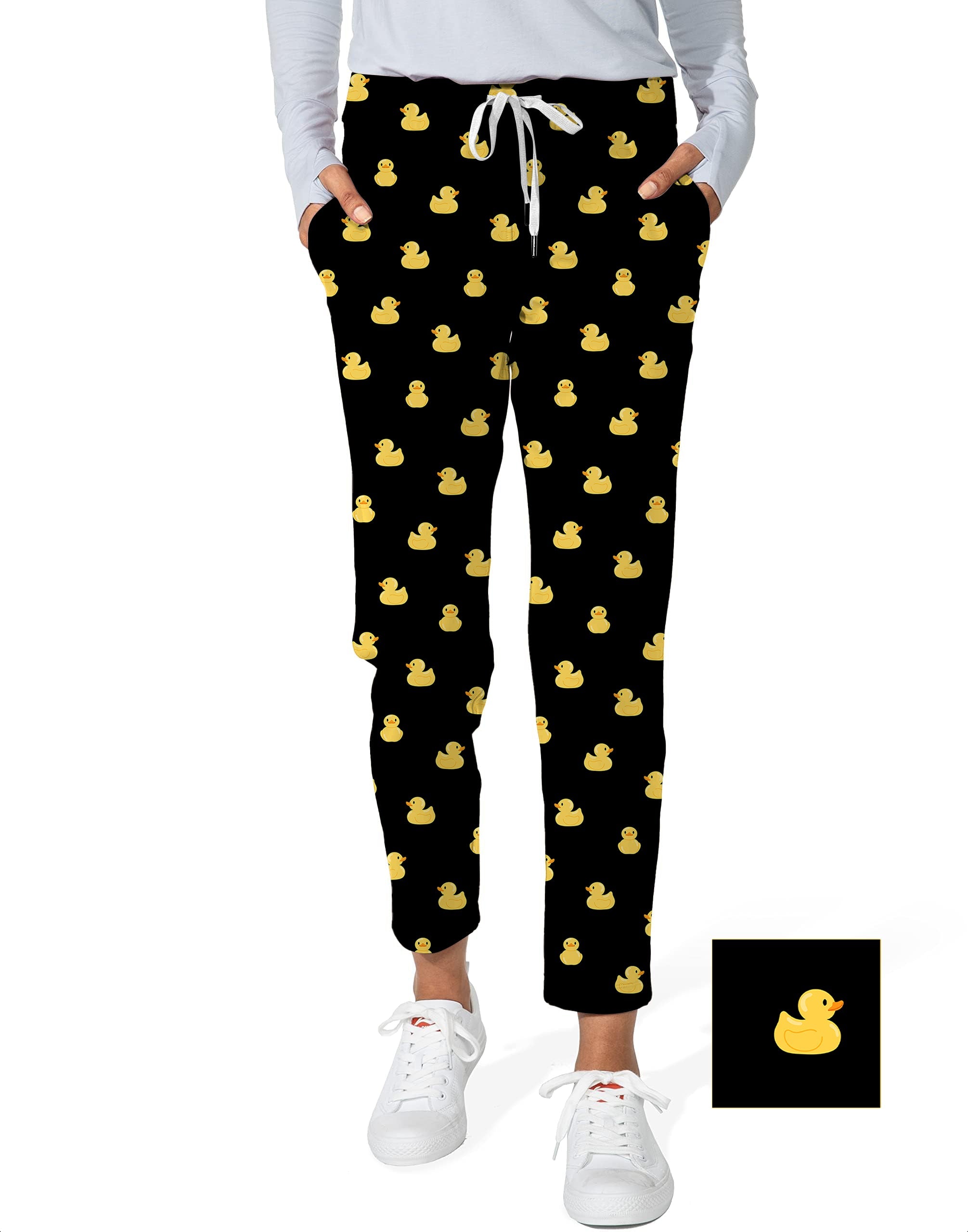 Women's black 7/8 stretch ankle golf pants with yellow rubber duck pattern and white drawstring