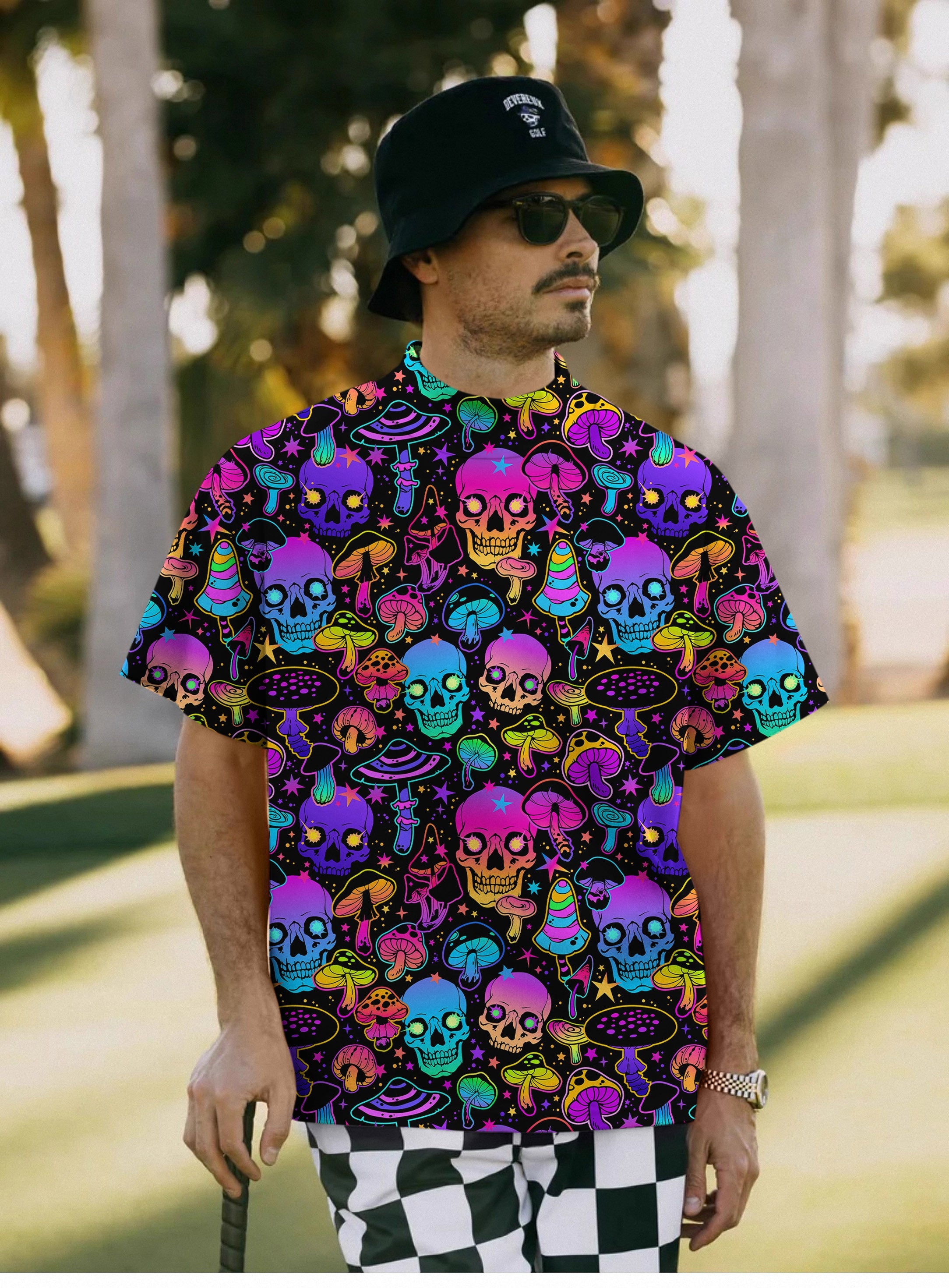 Men's neon skull pullover t-shirt with colorful skull and mushroom pattern, high neck, short sleeves, worn by man outdoors