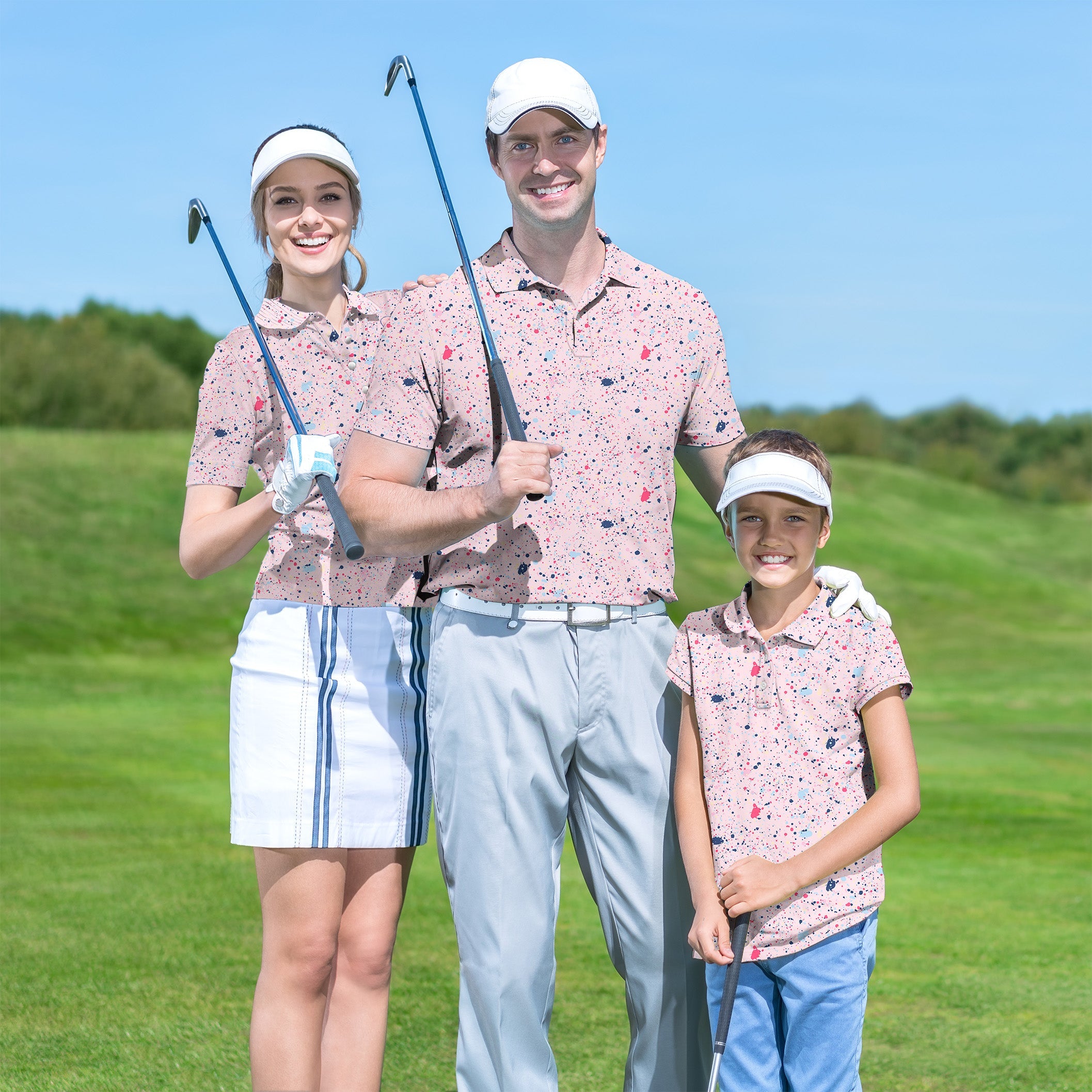 Family wearing matching black pink ink dots golf shirts on green golf course