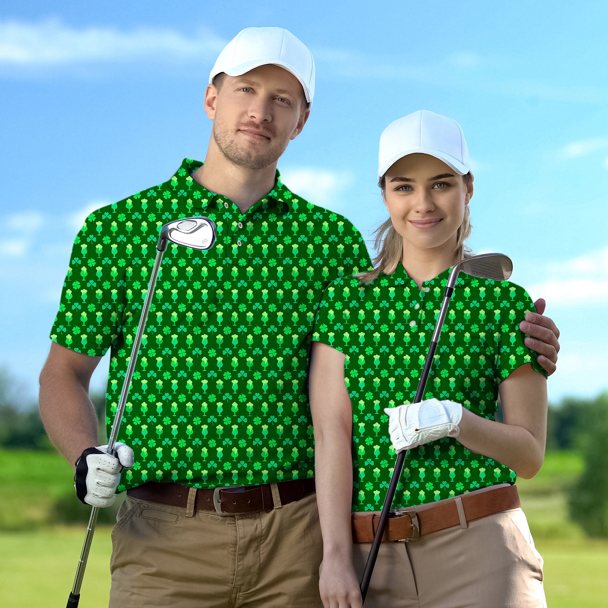 Couple wearing green clover leaf golf polo shirts with white caps holding golf clubs on golf course