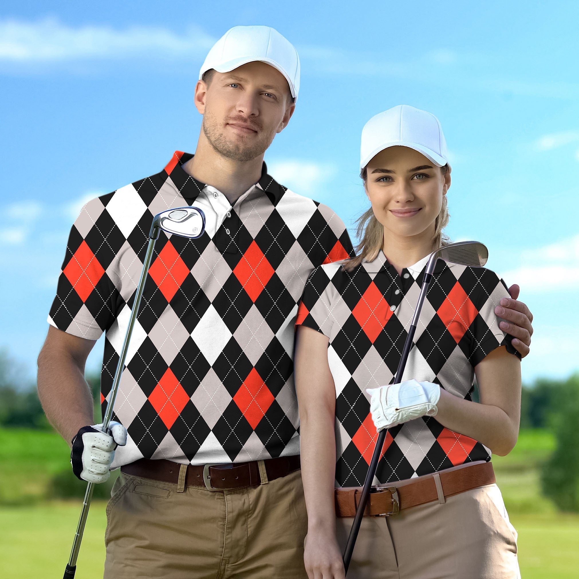 Couple wearing red and black argyle golf shirts holding clubs on golf course