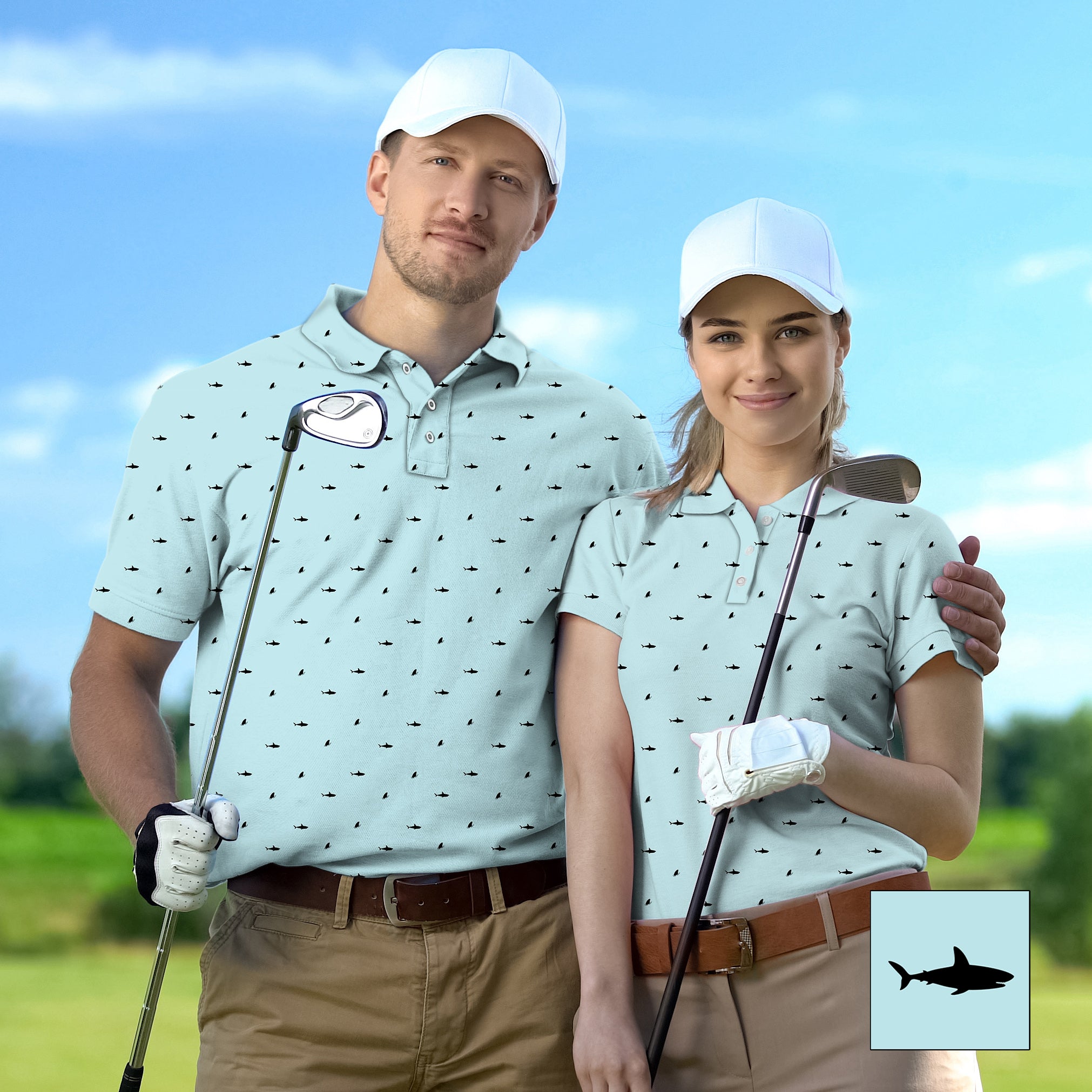 Couple wearing matching black shark print golf shirts with white caps on golf course