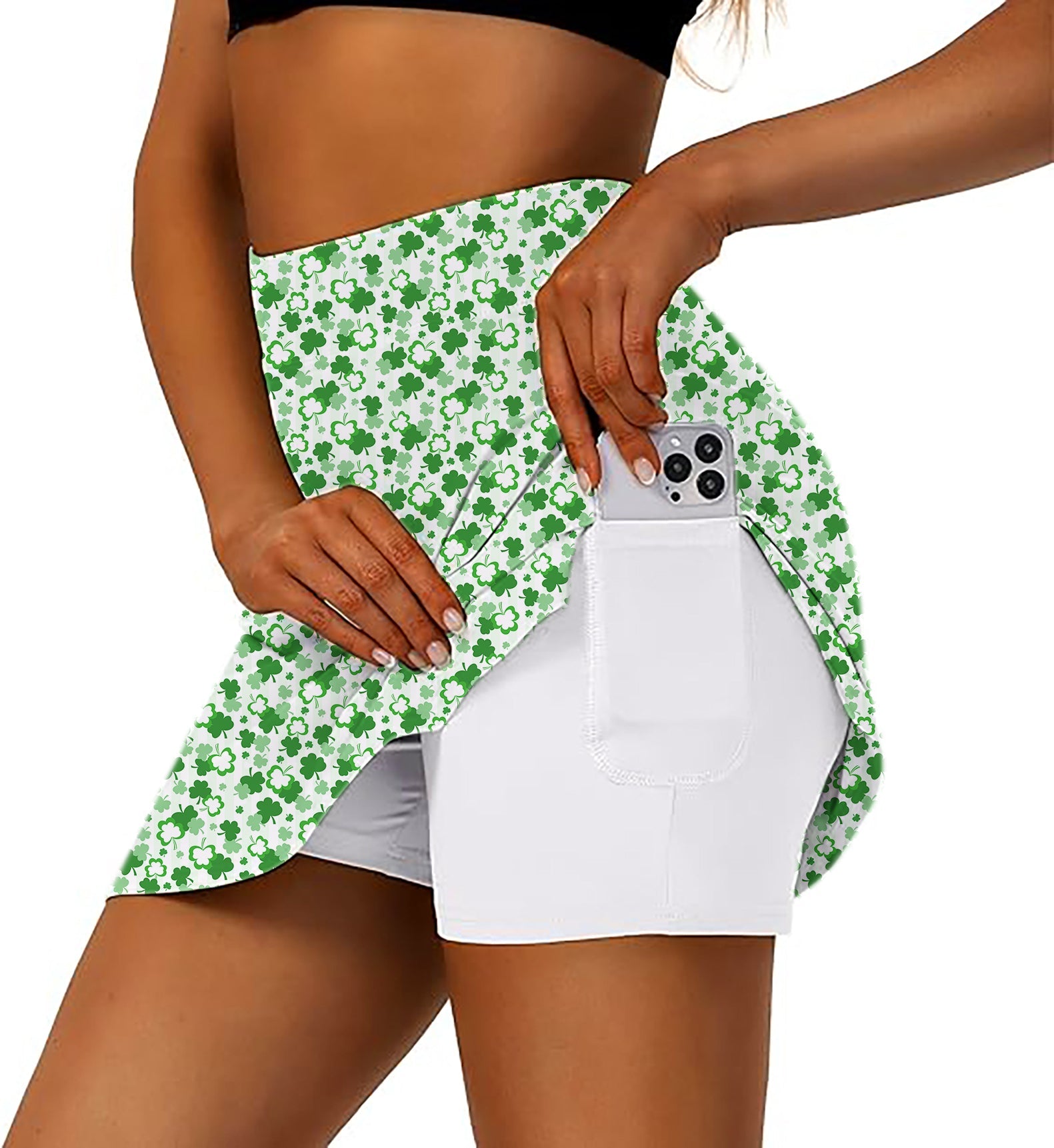 Women's athletic golf skorts with green leaf clover St. Patrick's Day pattern and phone pocket
