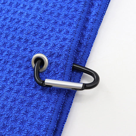Blue sports microfiber waffle towel with metal grommet and black carabiner clip close-up