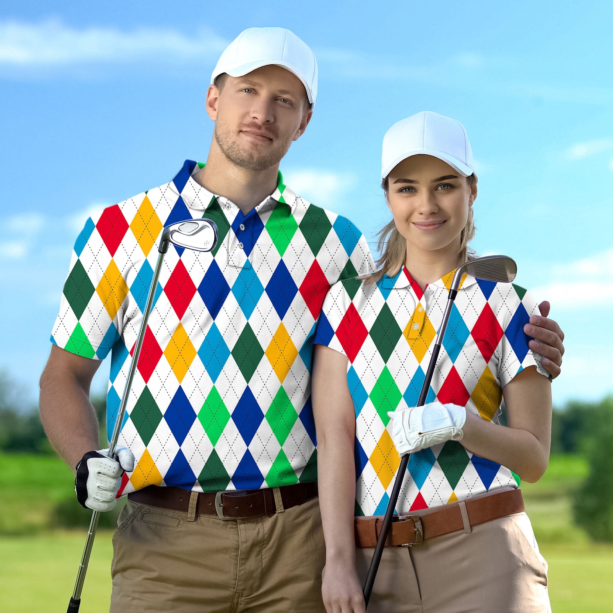 Couple wearing colorful argyle golf shirts with matching white caps holding golf clubs on a sunny golf course
