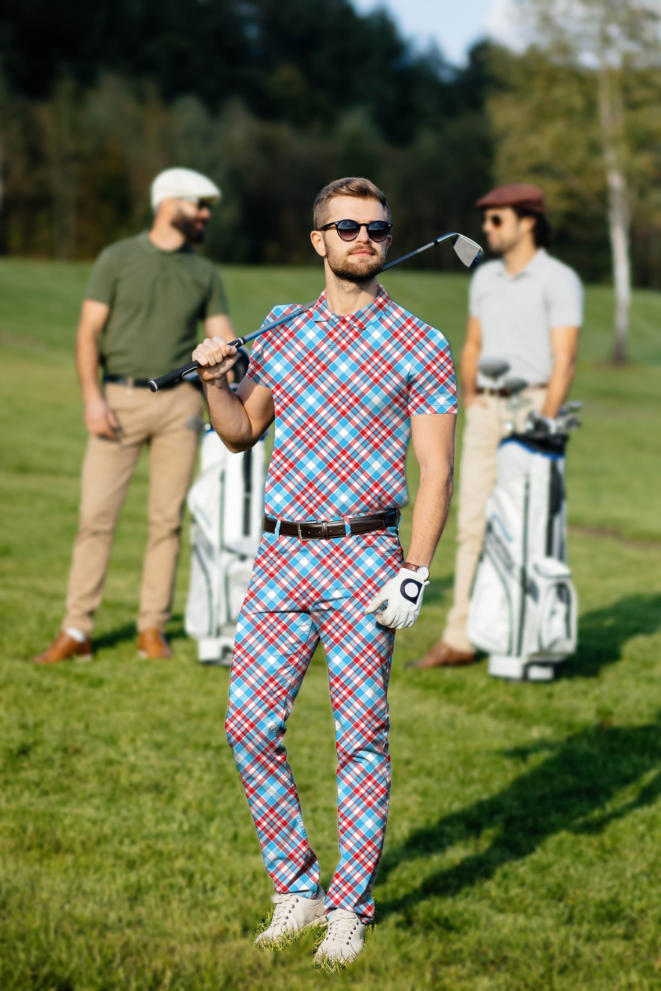 Men's golf set with red and blue argyle polo and pants on a golf course