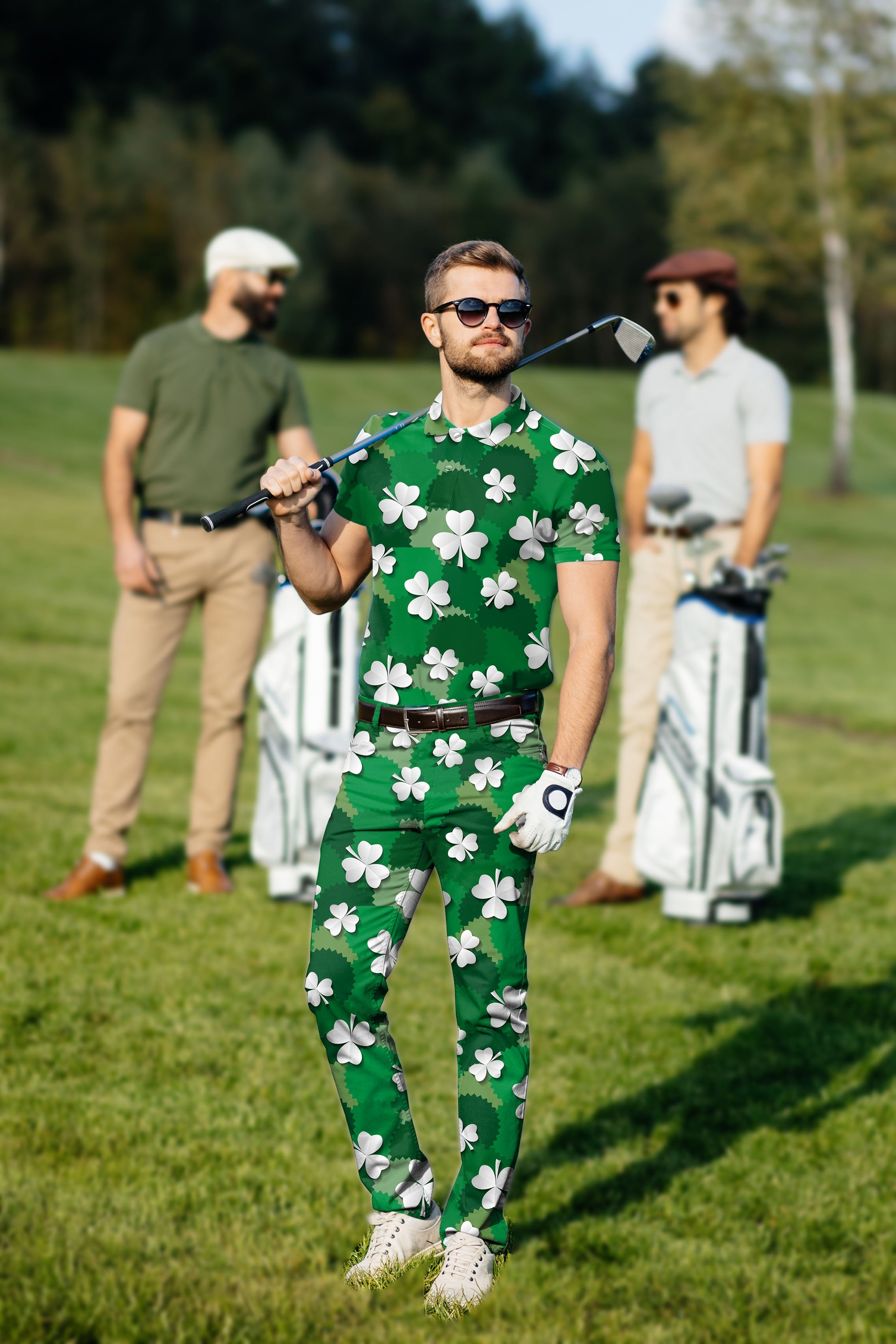 Men's golf set featuring green polo and pants with white leaf clover print for St. Patrick's Day, made with moisture-wicking, stretchy, wrinkle-resistant fabric and UPF 40+ protection.