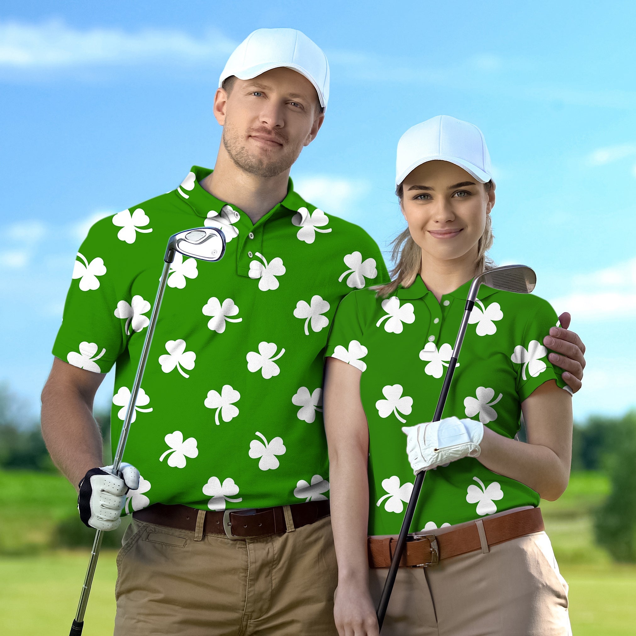 Couple wearing green leaf clover patterned golf shirts with white caps holding golf clubs on a sunny course