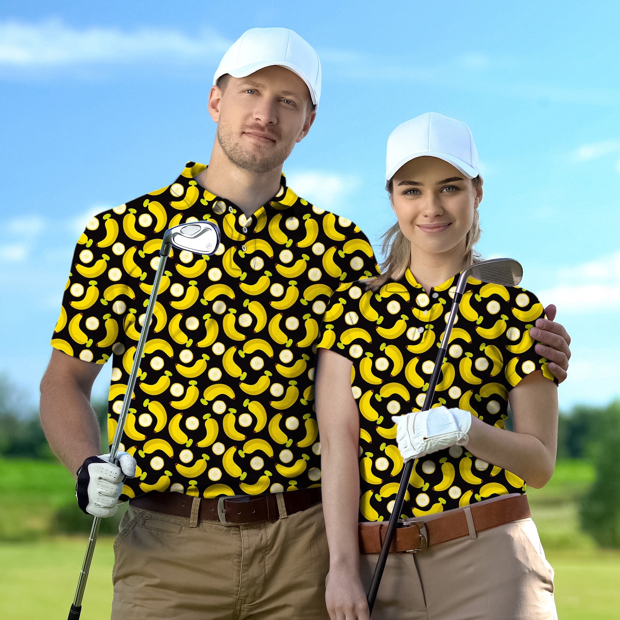 Couple wearing matching Halloween banana print golf shirts holding clubs on course