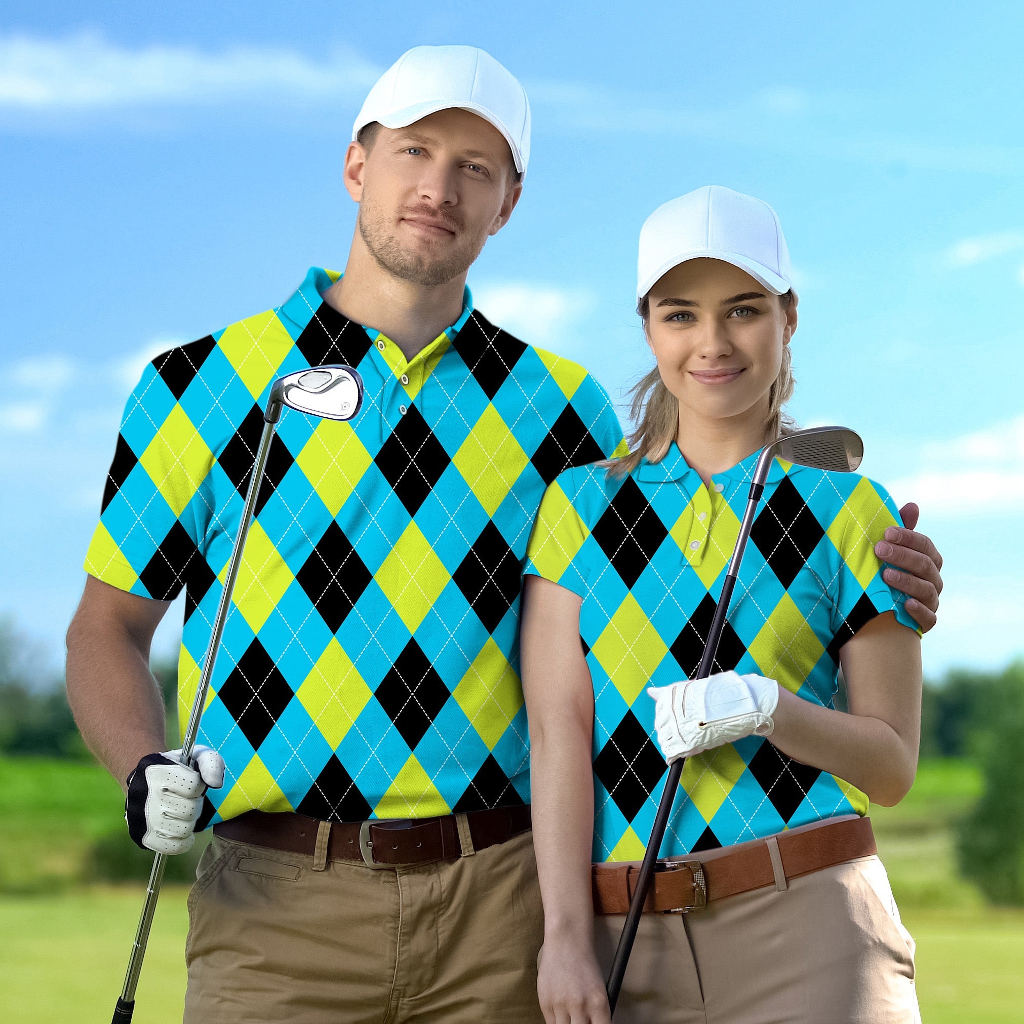 Couple wearing black green blue white argyle golf shirts with white caps holding golf clubs on green field