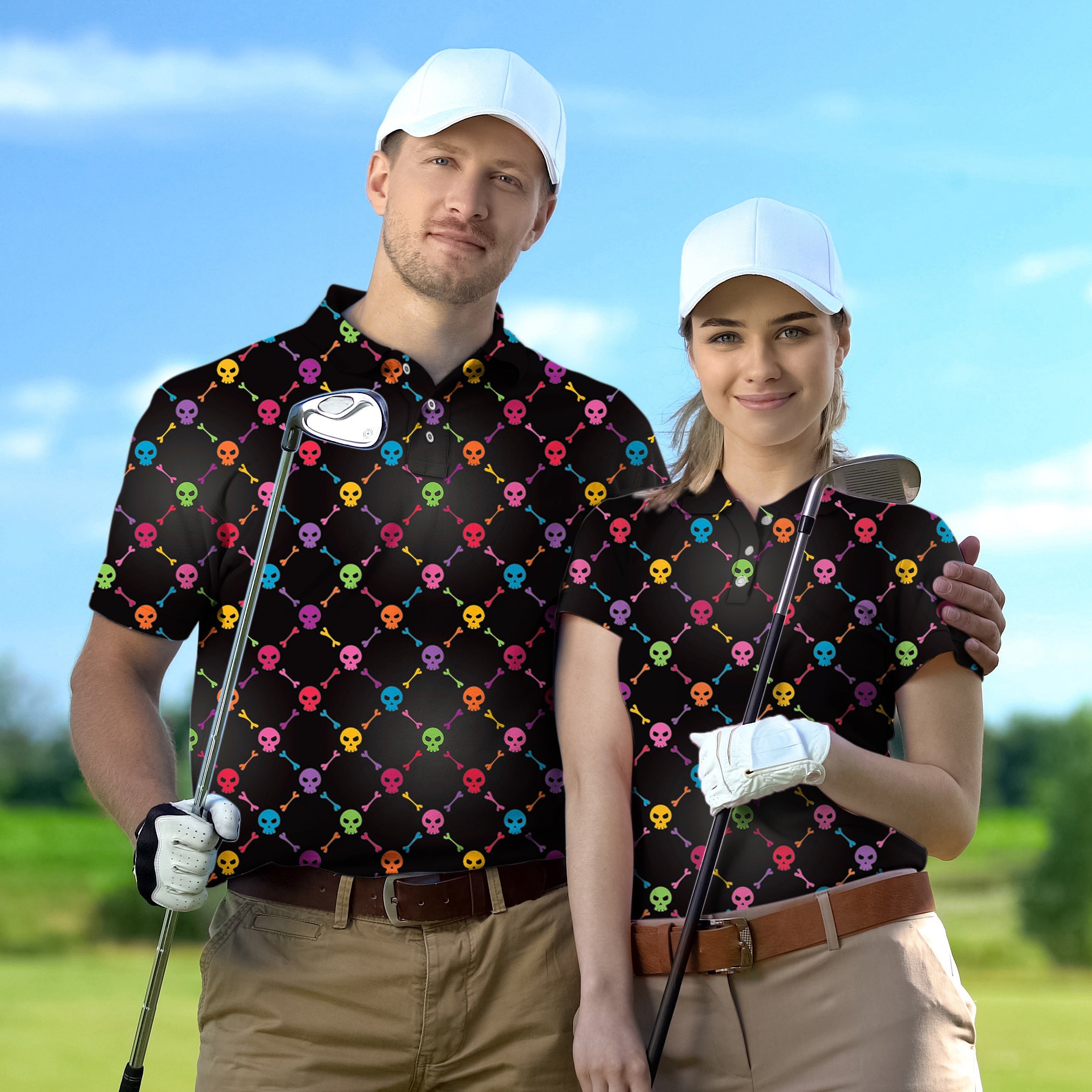 Couple wearing matching Halloween colors skull bones golf shirts holding clubs on a golf course