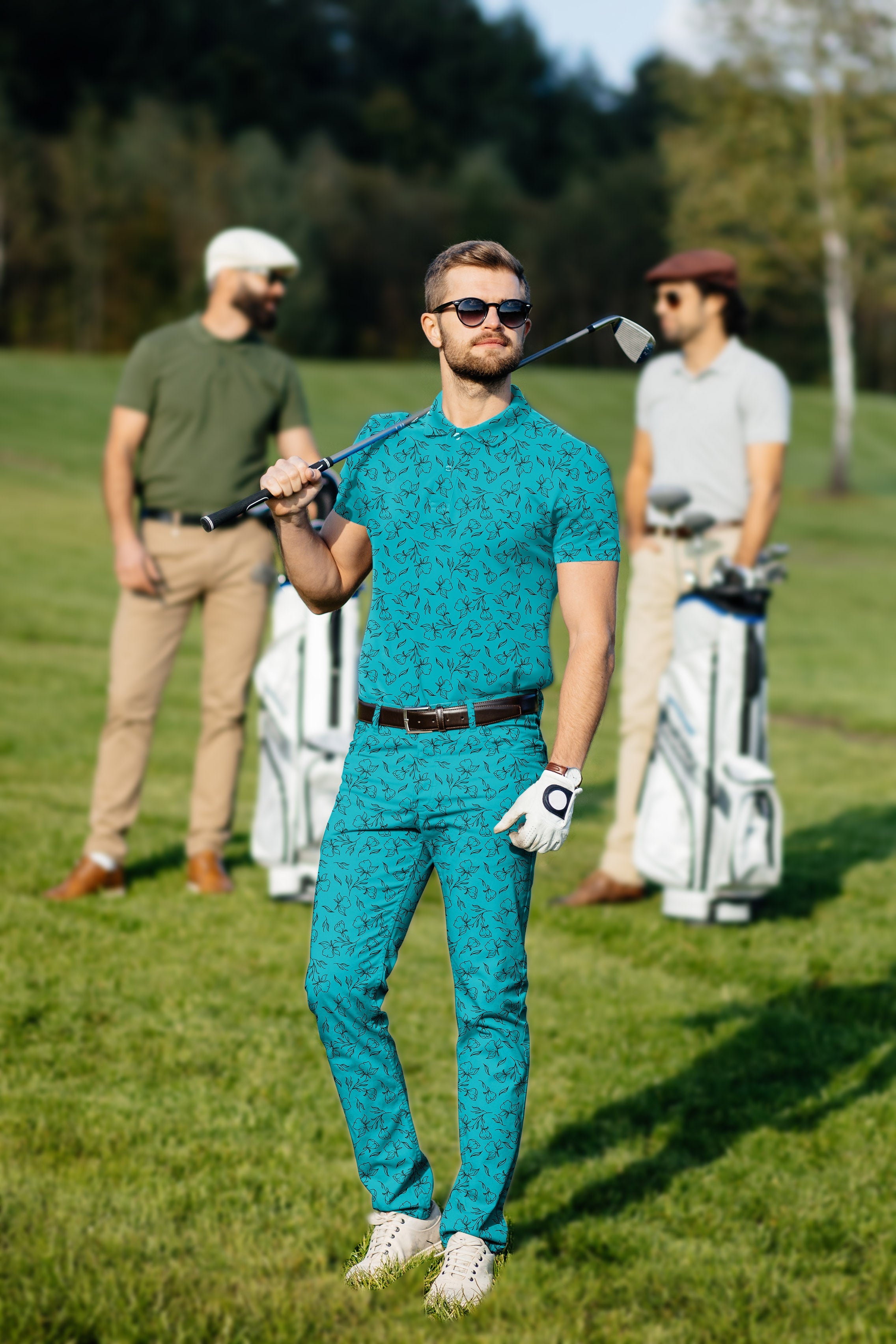 Men's golf set with teal floral polo and pants, four-way stretch, moisture-wicking, wrinkle-resistant, UPF 40+ protection, classic fit, and stay-right collar.