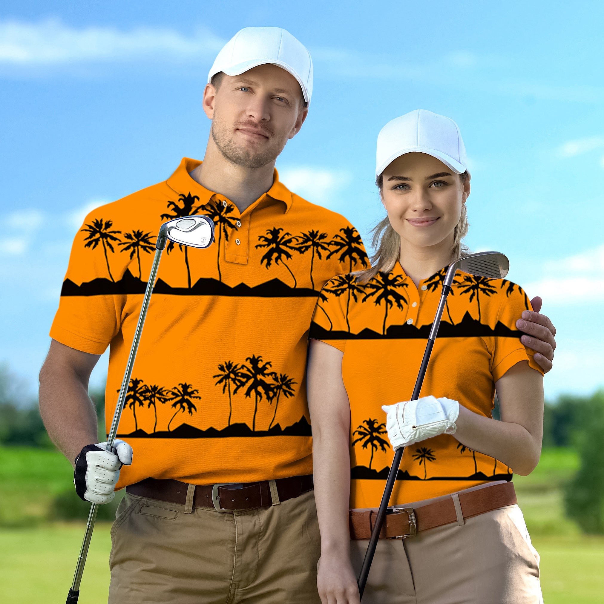 Couple wearing matching orange tropical golf shirts with palm tree and sunset design holding golf clubs outdoors