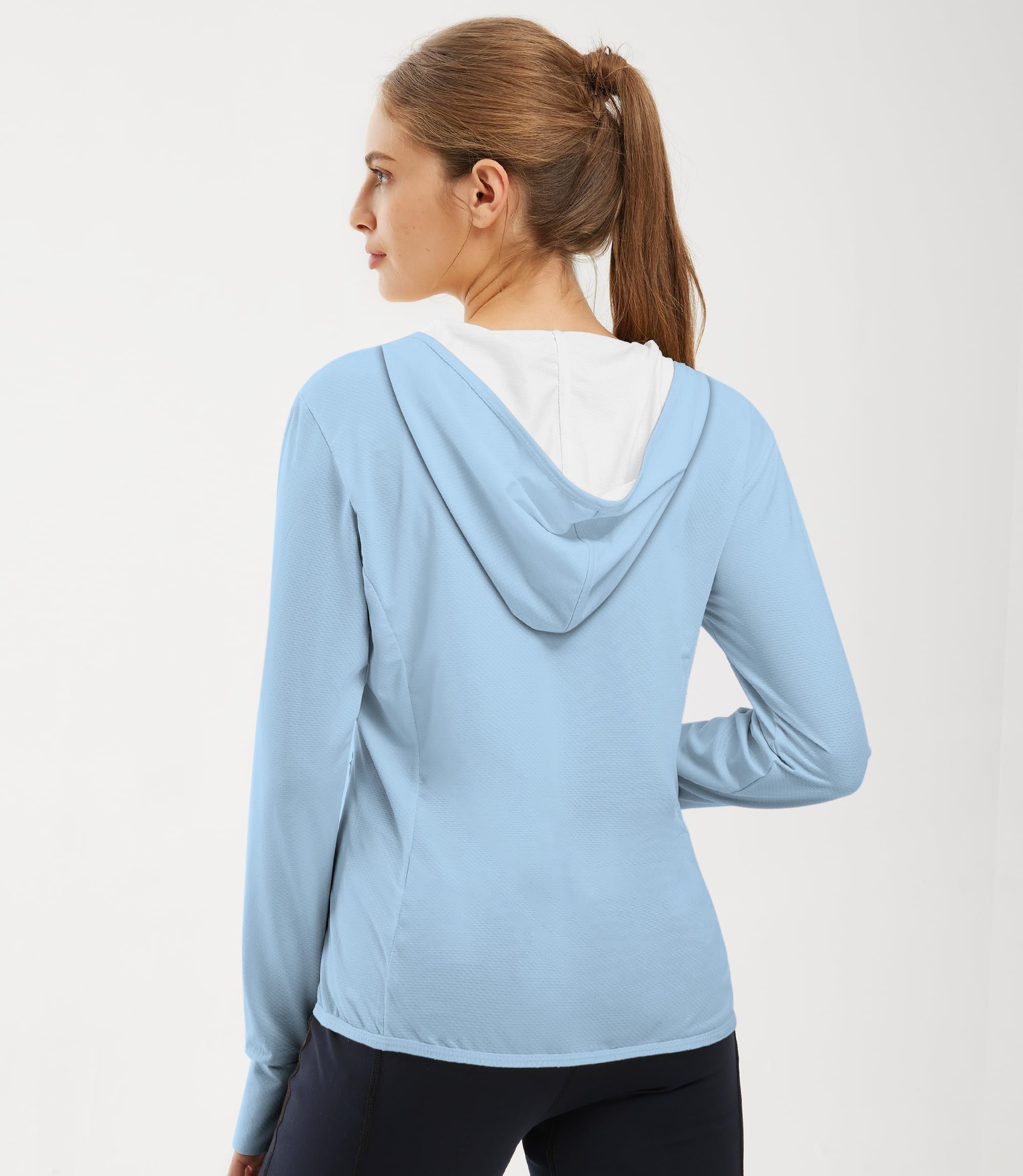 Women wearing light blue outdoor slim fit zip hoodie with hood up, back view