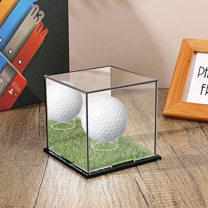 Golf tees set with personalized golf ball in clear display holder on wooden surface