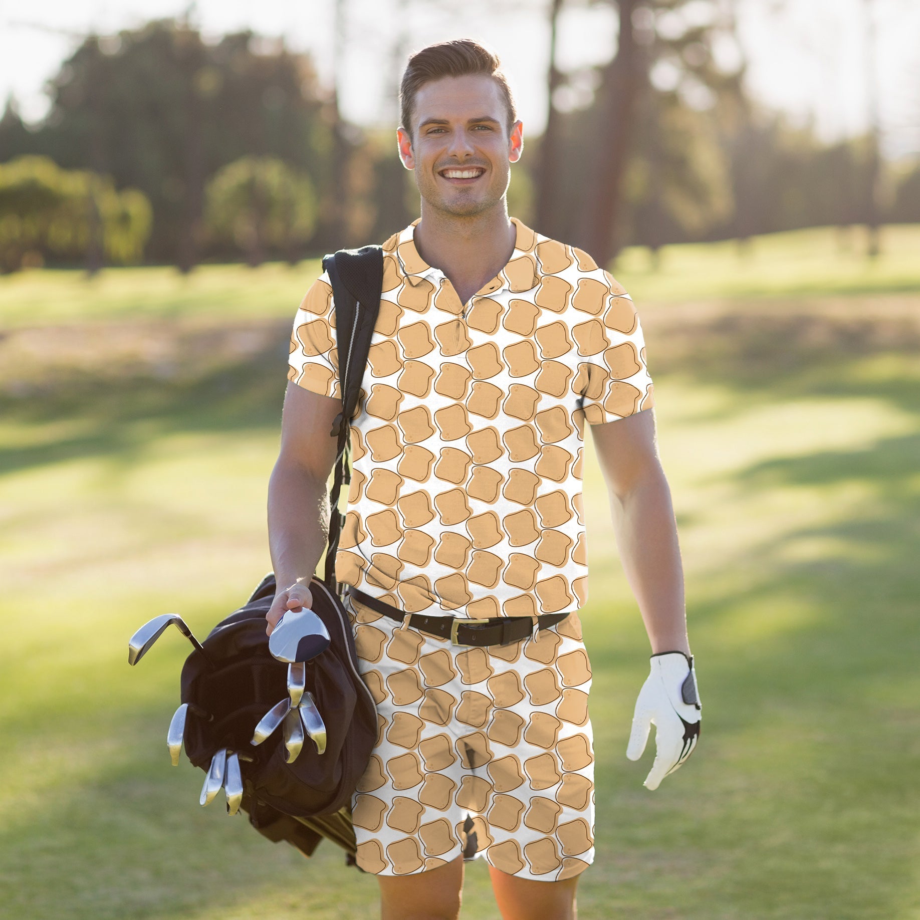 men's golf set with patterned polo shirt and shorts carrying golf bag on course