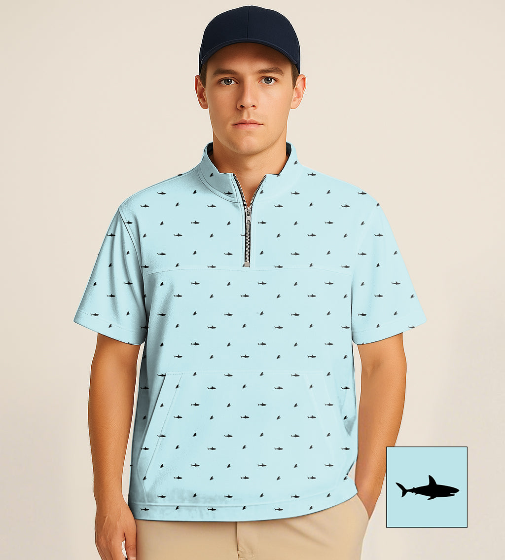 Male model wearing light blue half zipper turtleneck golf shirt with black shark fin pattern and short sleeves