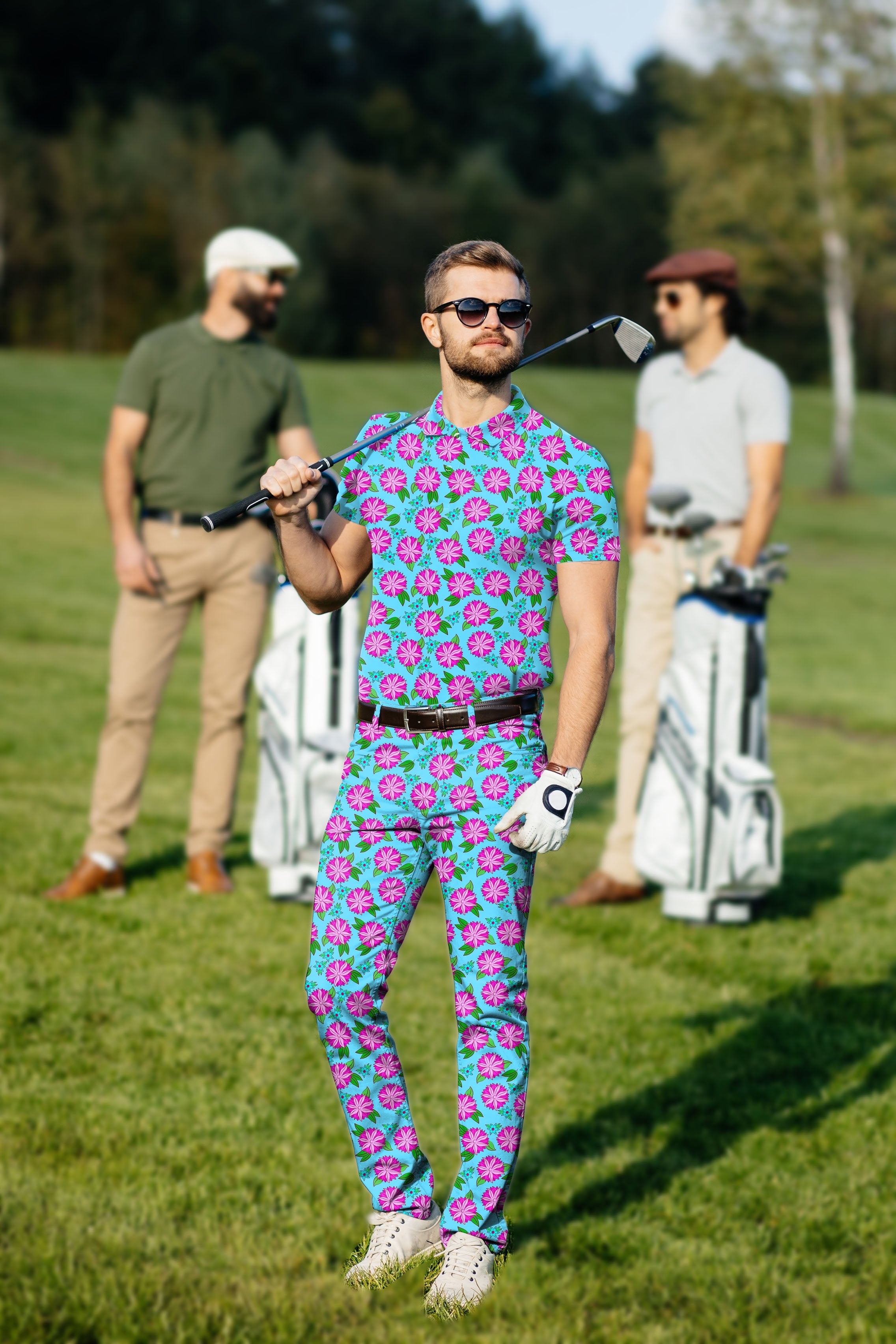 Men's golf set with vibrant flower pattern polo and pants, high-performance stretch fabric, and UV protection.
