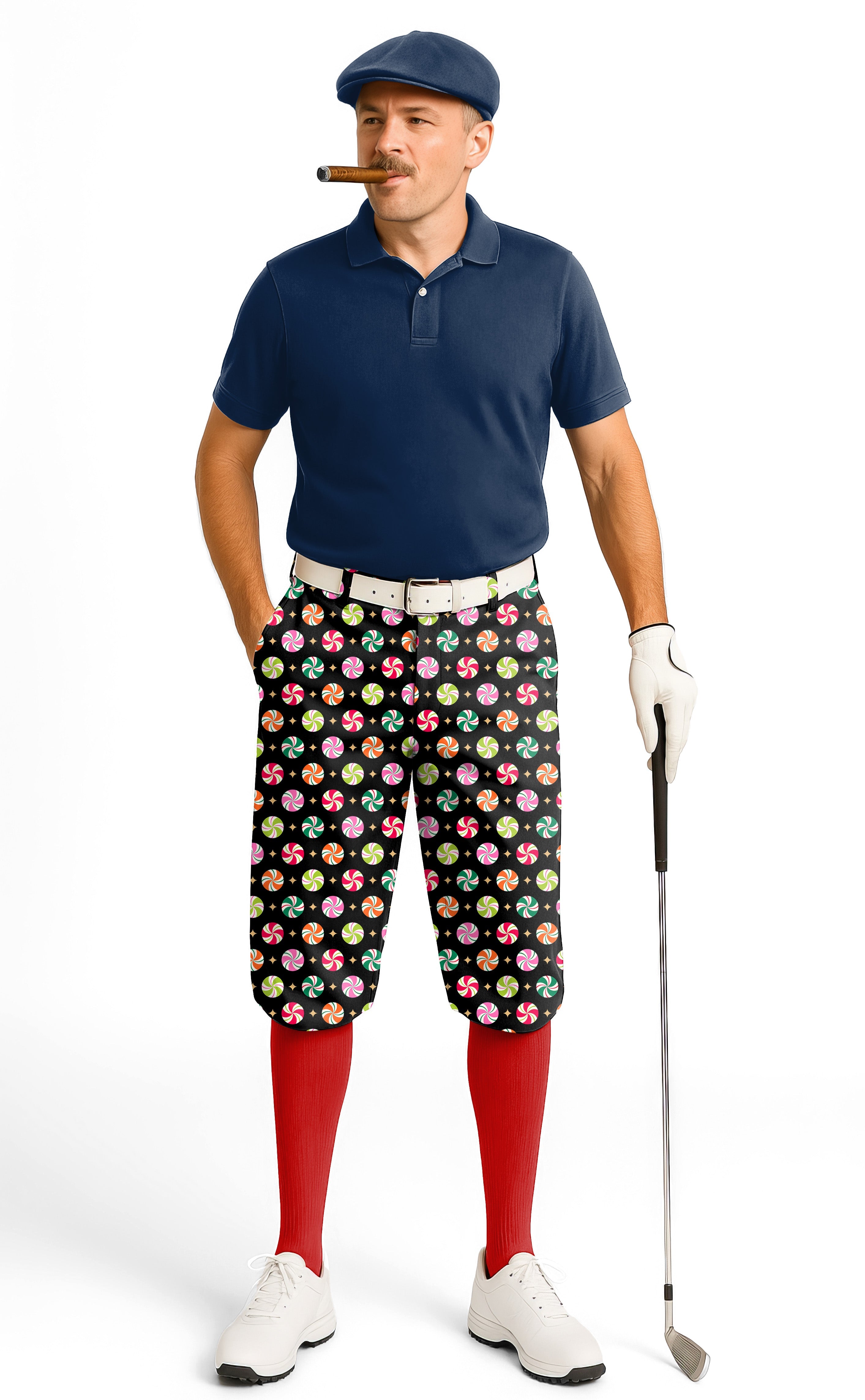 Man wearing Christmas Candy Men's Golf Knickers with colorful candy print, navy polo, red socks, and white golf shoes holding a golf club.