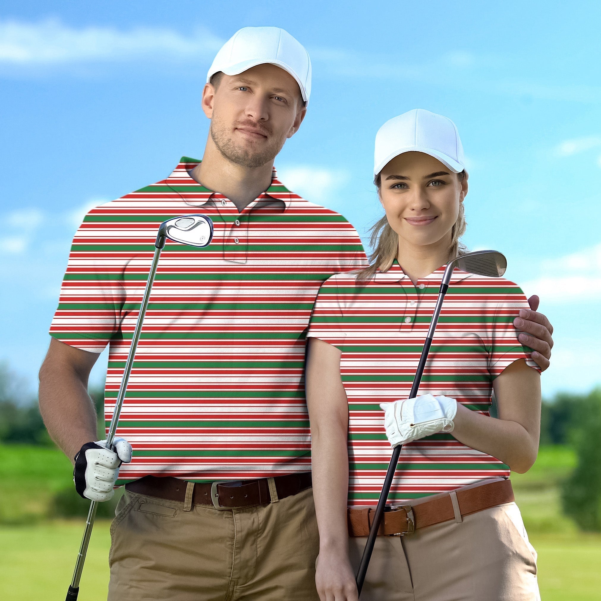 Couple wearing striped Christmas golf shirts with white caps holding golf clubs on the course