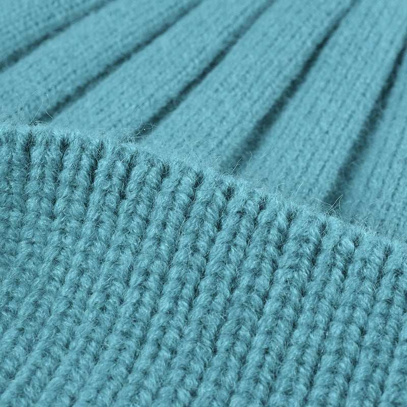 Close-up of blue knitted fabric for custom embroidered hats with winter design and durable texture