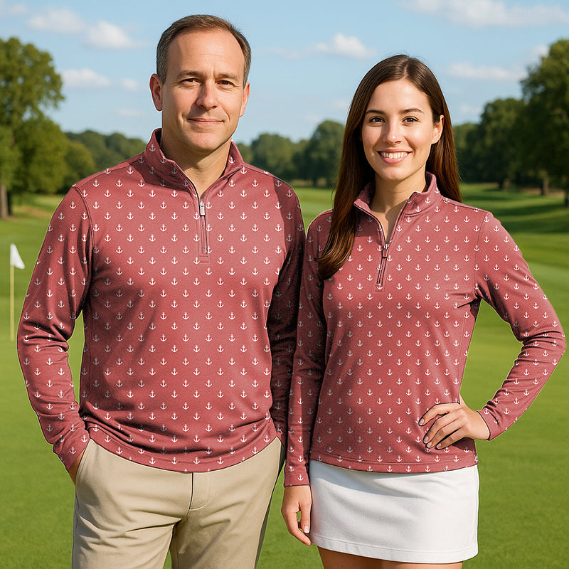Couple wearing pink red anchor print golf active 3/4 zip tops with mock collars outdoors on golf course