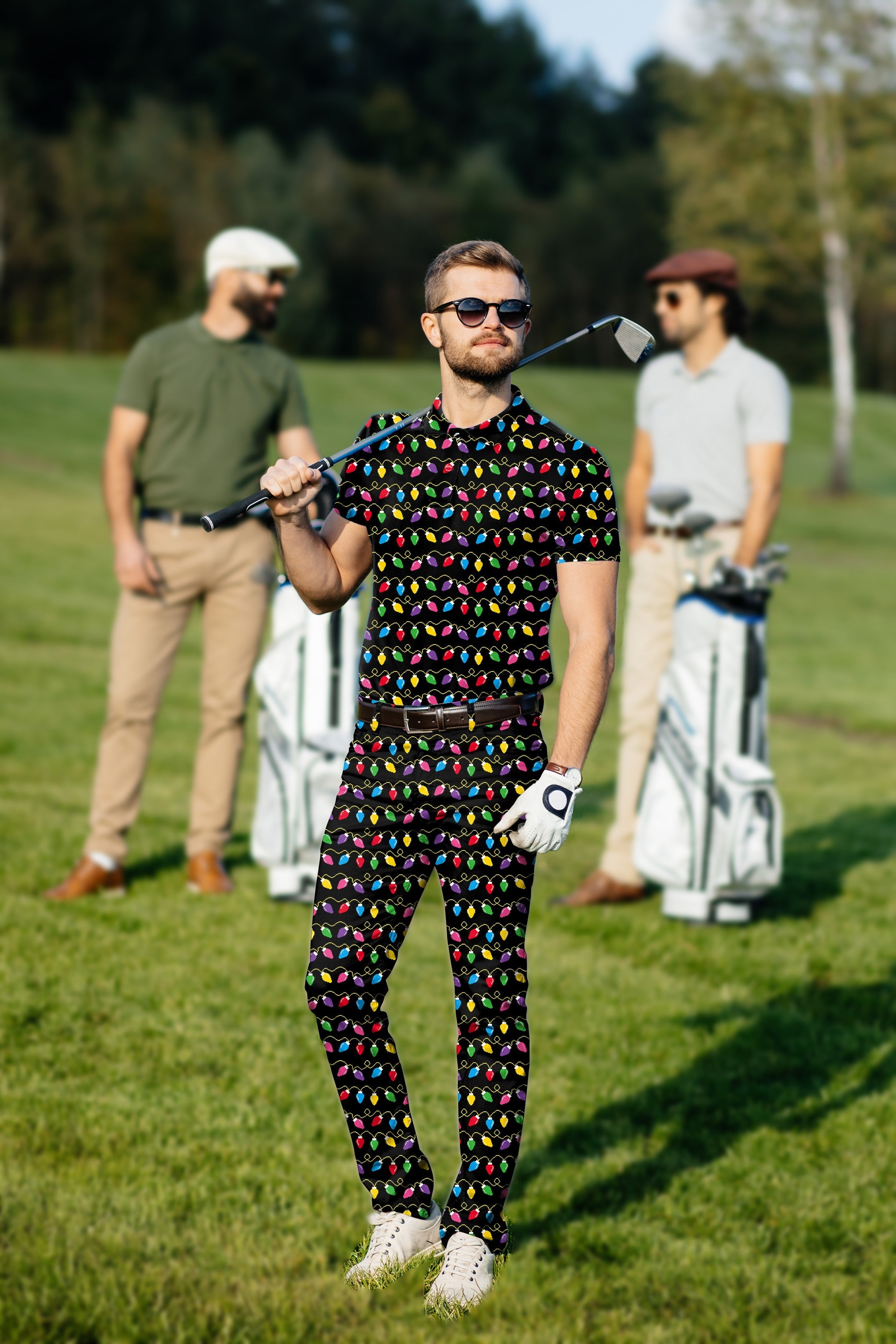 Men's Golf Set with colorful Christmas lights pattern polo and pants on a golfer on a green course