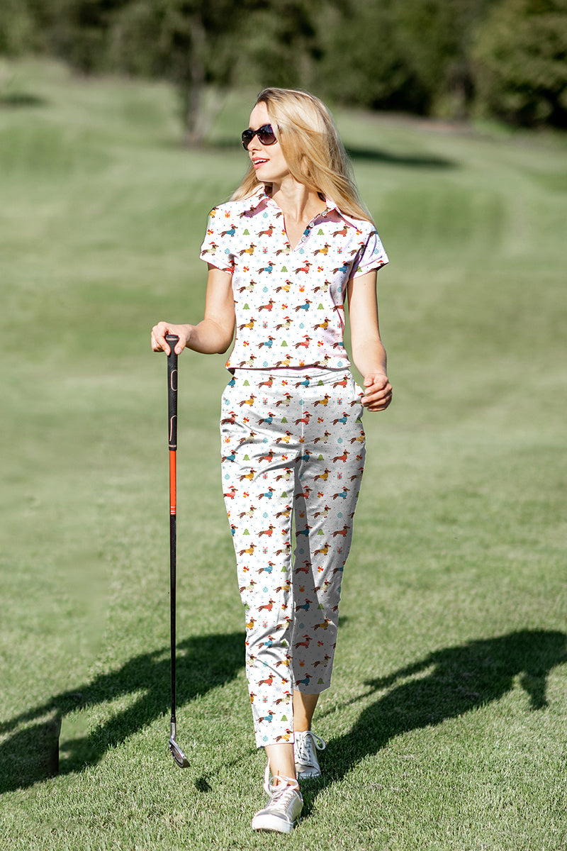 Women's golf polo and pants set with colorful dachshund print, four-way stretch, moisture-wicking fabric, UPF 40+ protection, and classic fit.