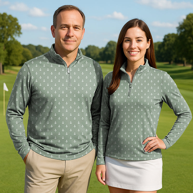 Couple wearing light green anchor print 3/4 zip golf tops with long sleeves on a golf course